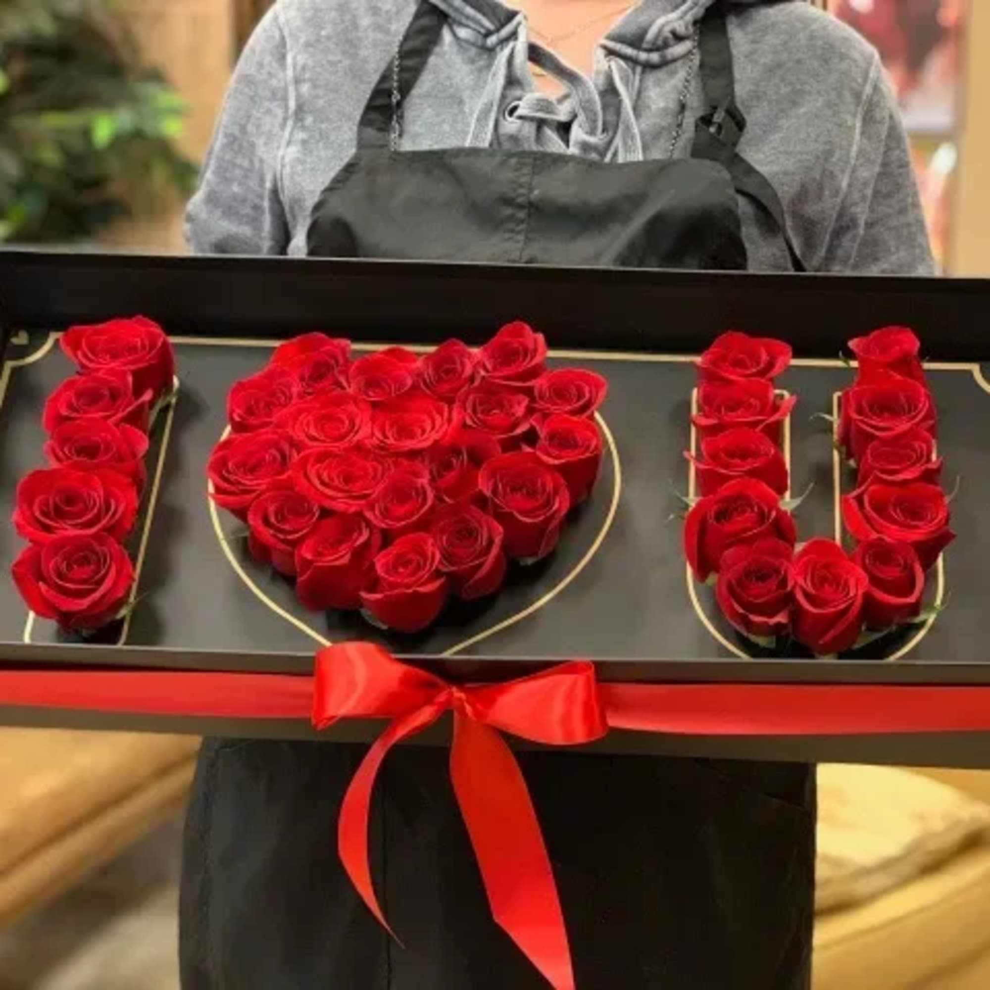 Boxed red roses arranged as the word I love you