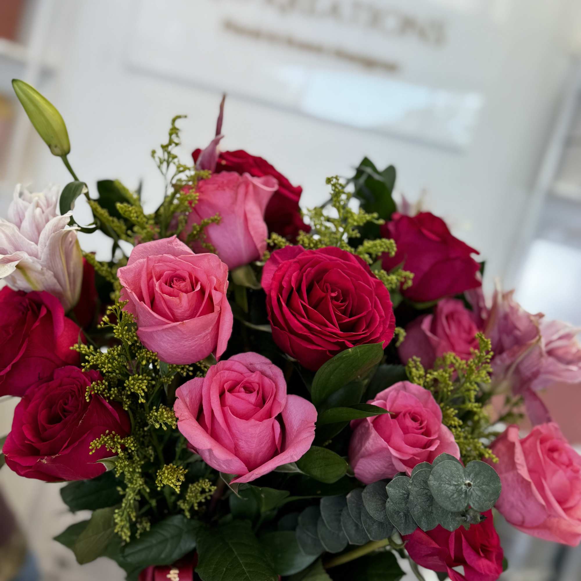 Bouquet of pink and red roses with small filler flowers