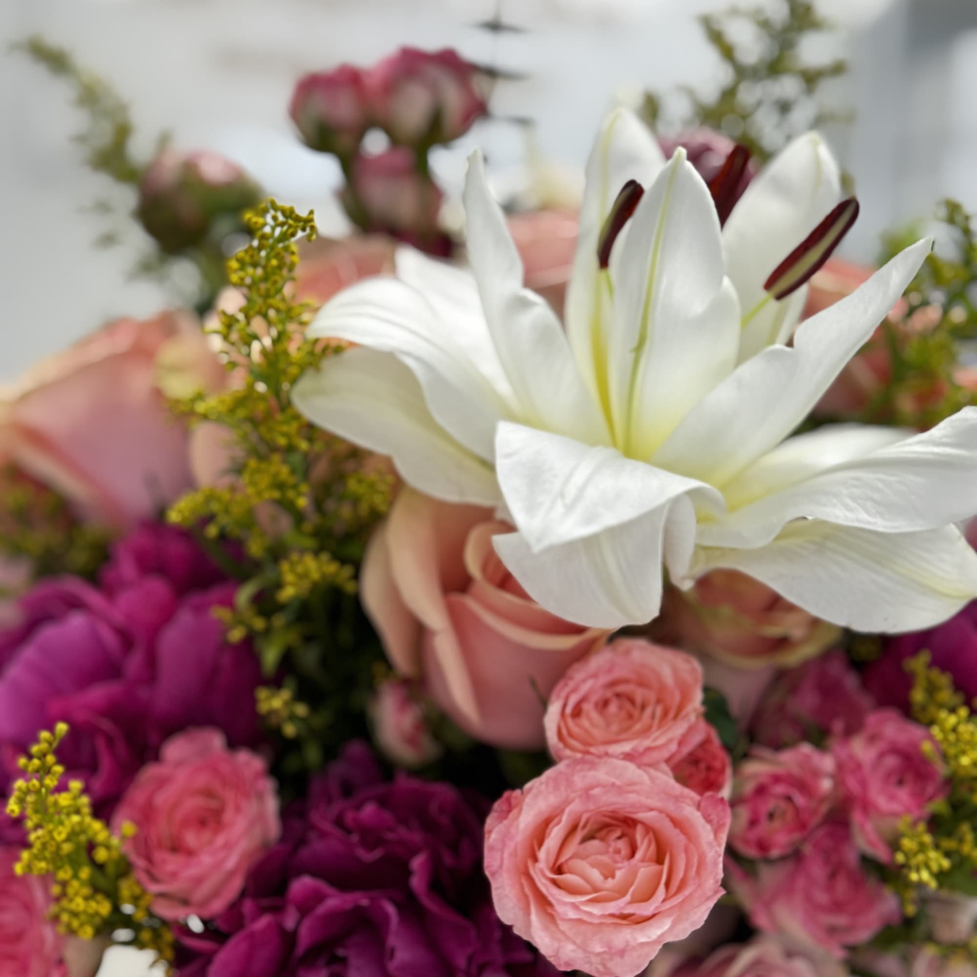 Pink and white floral bouquet with a large white lily