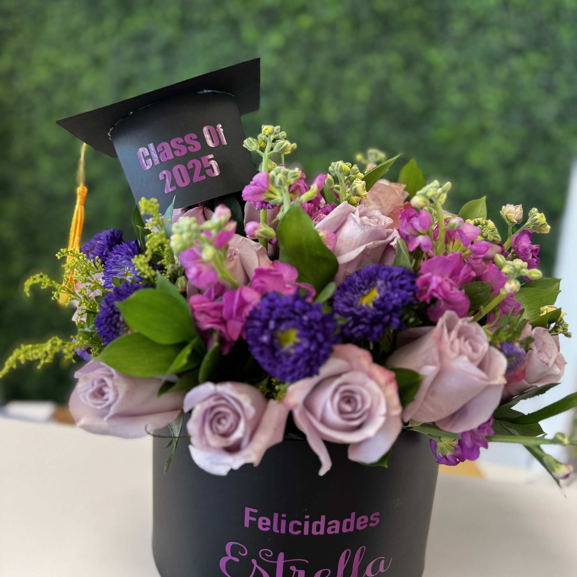 Lavender roses and purple flowers in a black graduation box with a cap topper