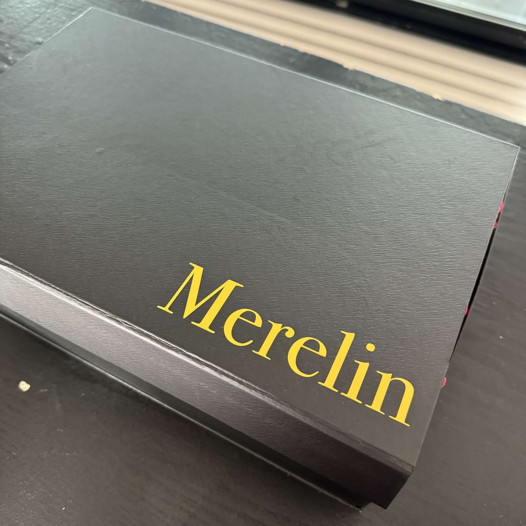 Black gift box with the name Merelin in gold lettering