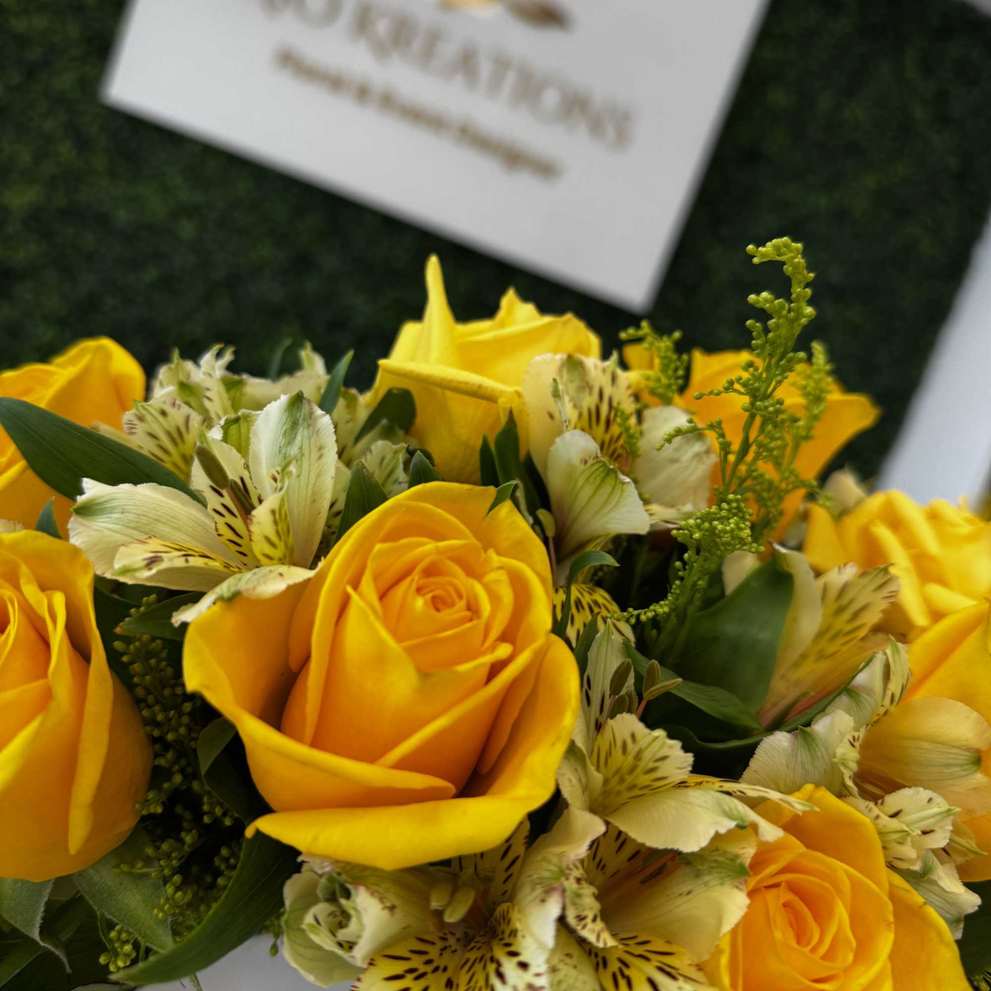 Yellow roses with spotted alstroemeria in a white box