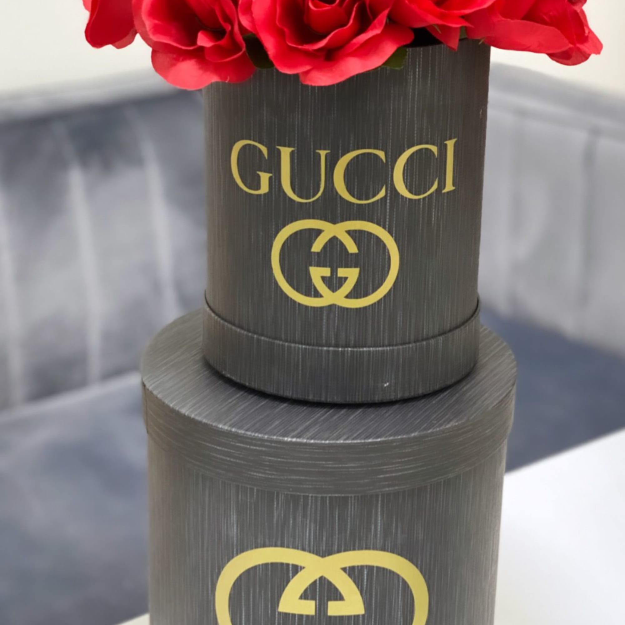 Red roses arranged in a black Gucci box