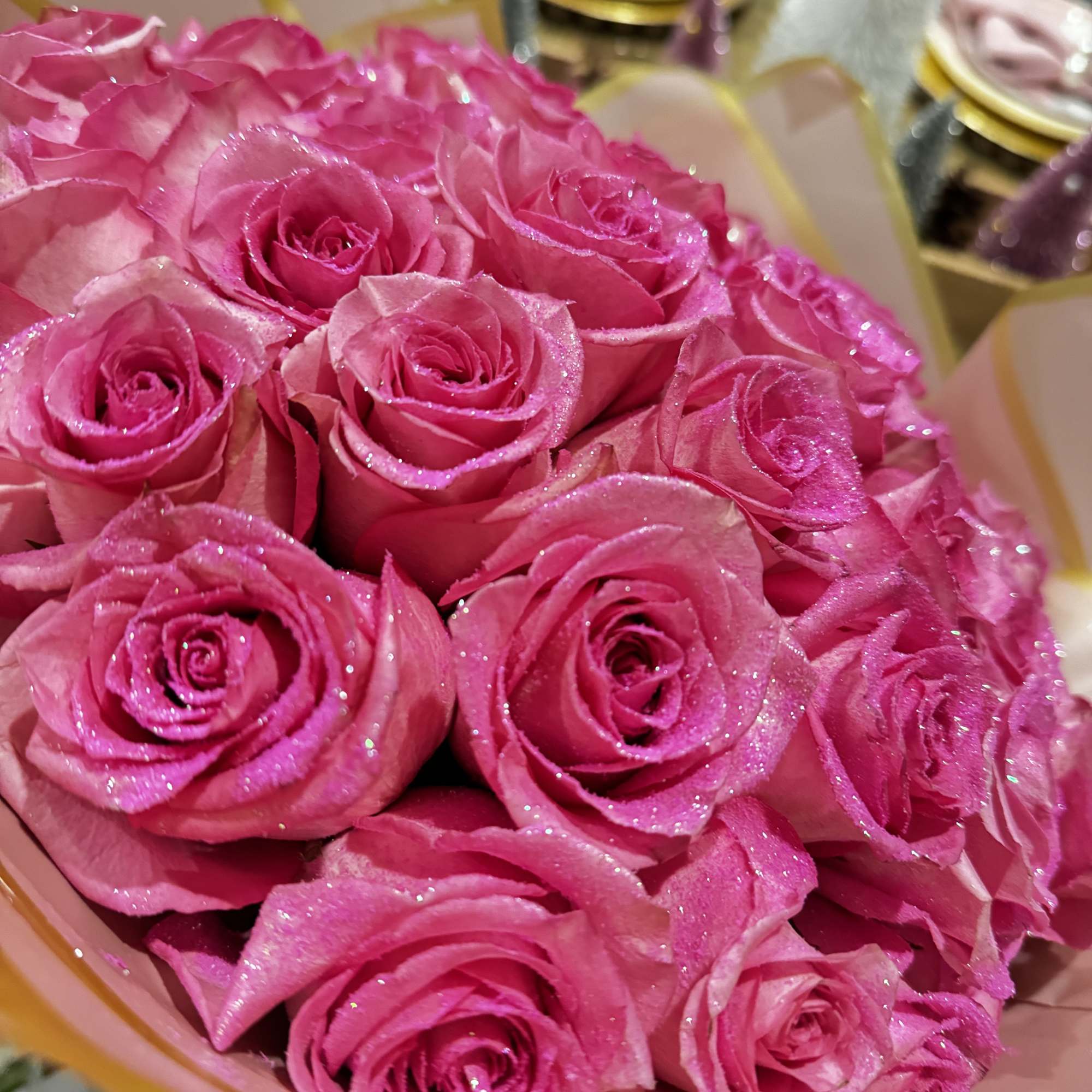 Bouquet of bright pink roses with glittery petals