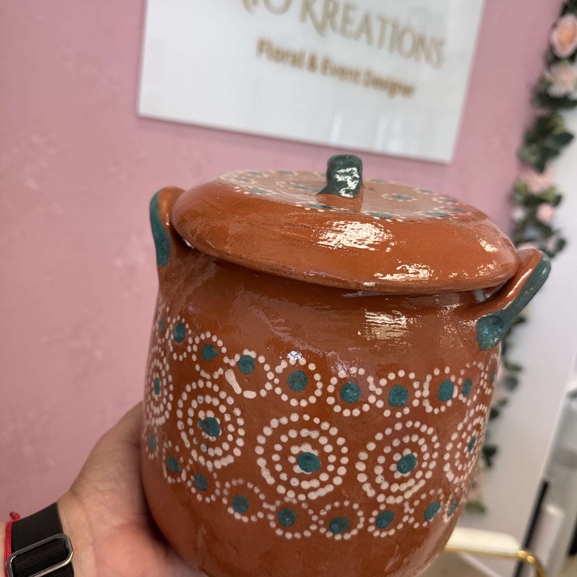 Handheld painted ceramic pot with a lid and dotted pattern