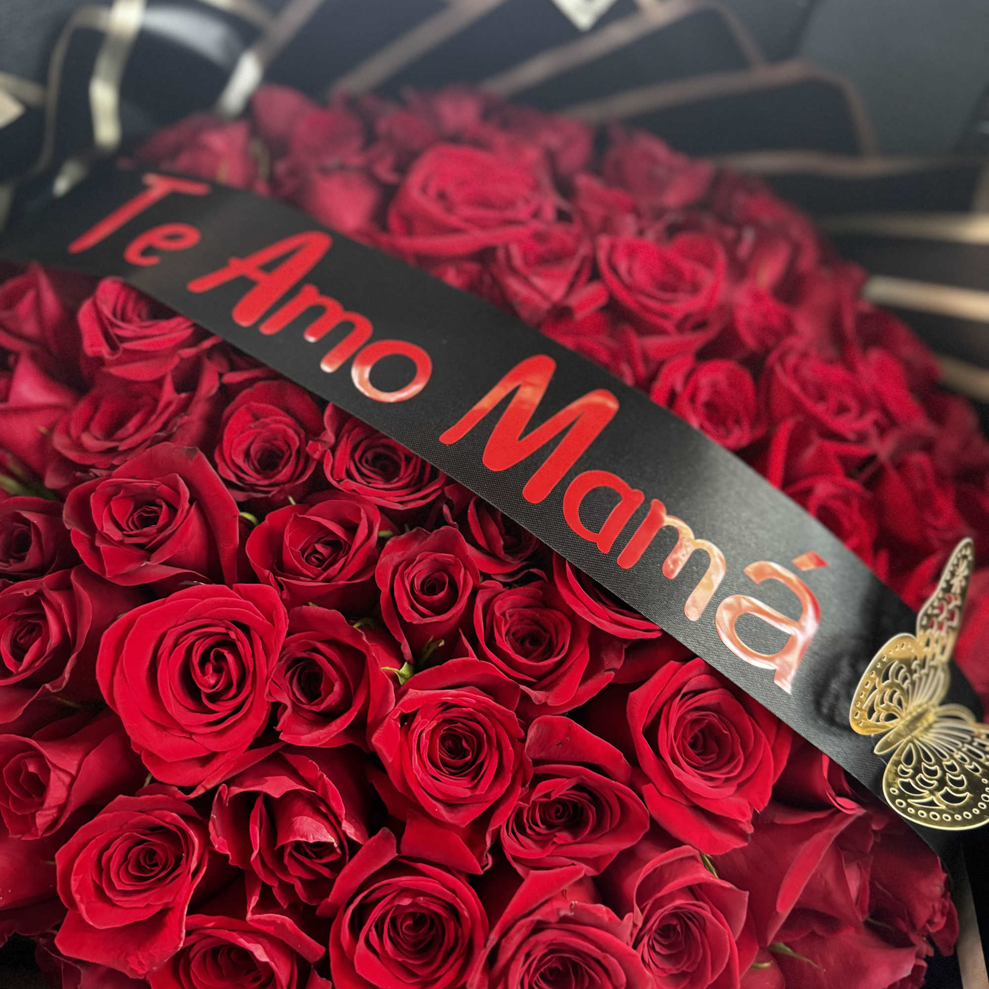 Bouquet of red roses with a black ribbon and butterfly decoration