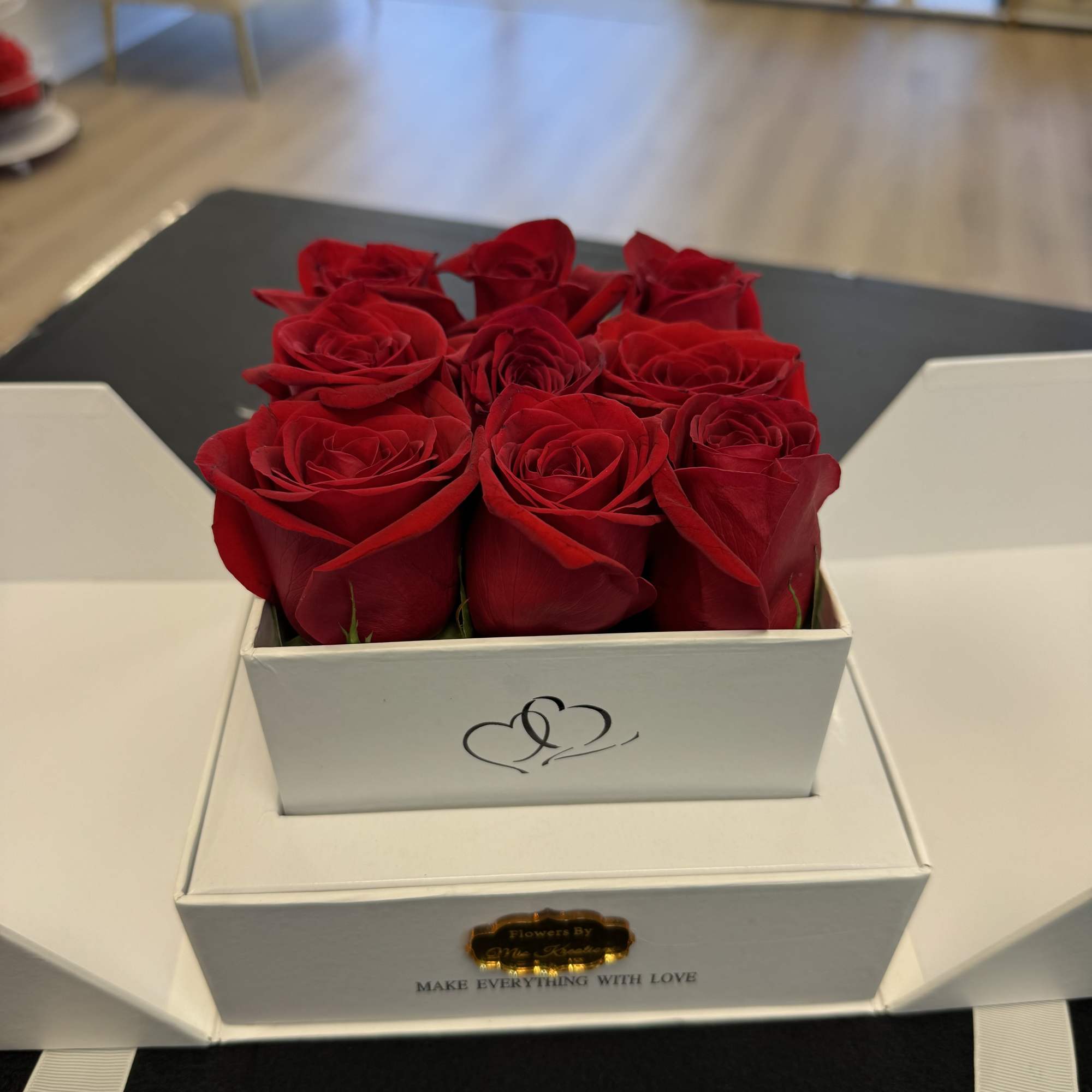 Red roses arranged in a white gift box