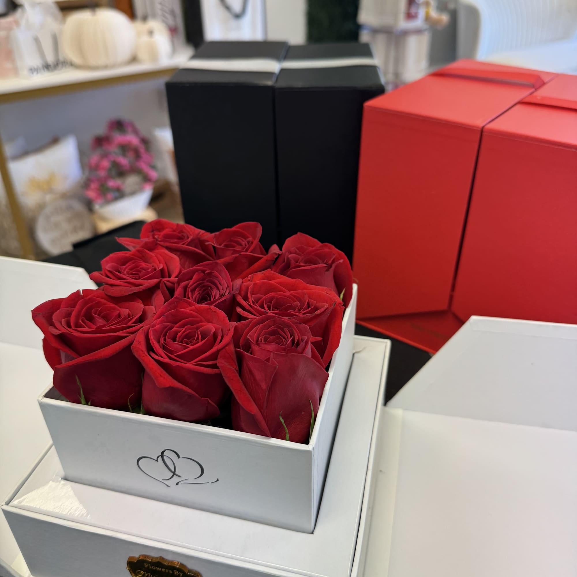 Red roses arranged in a white gift box with a lid
