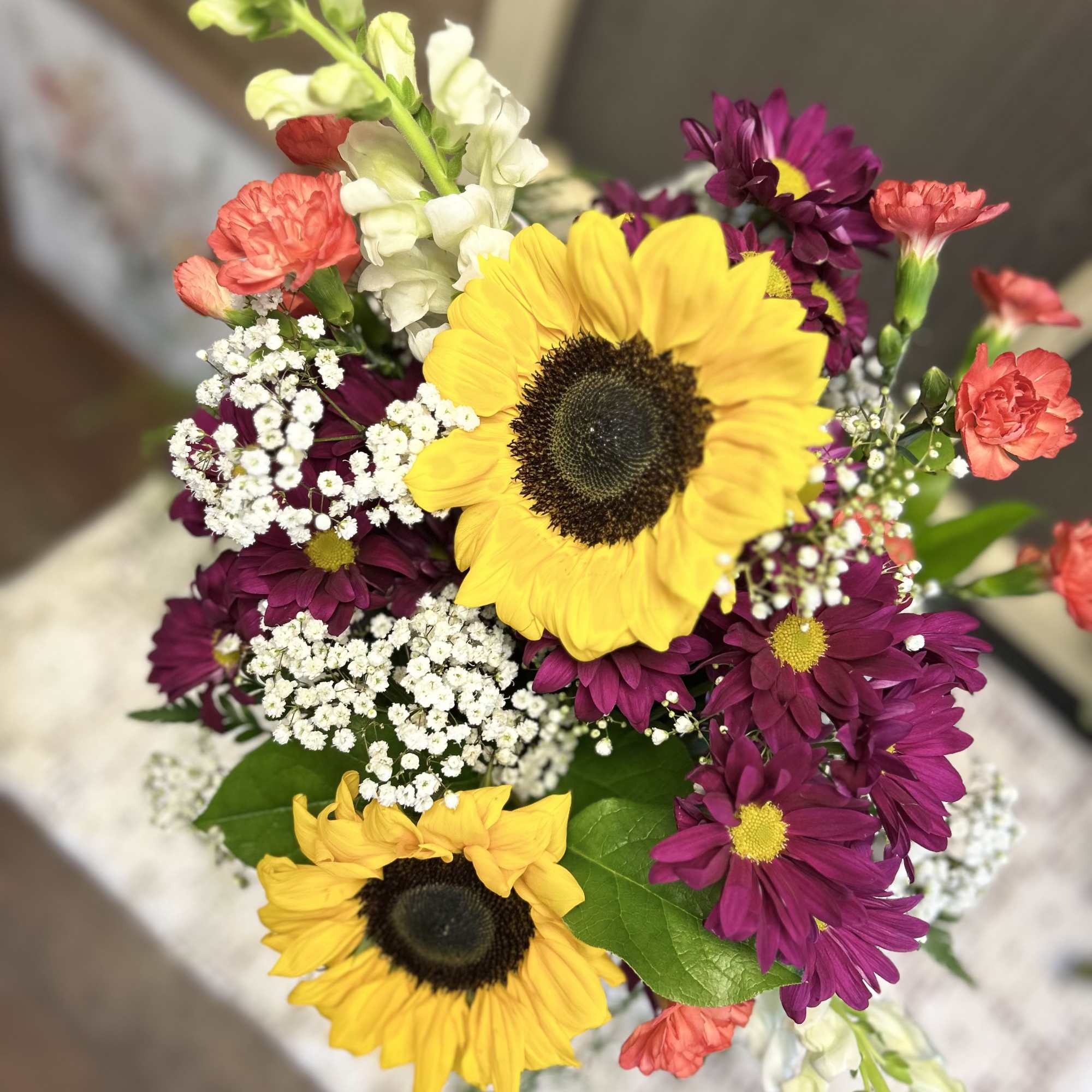 The colorful arrangement gives a bold statement sunflowers leading the way. , photo 2 of 2