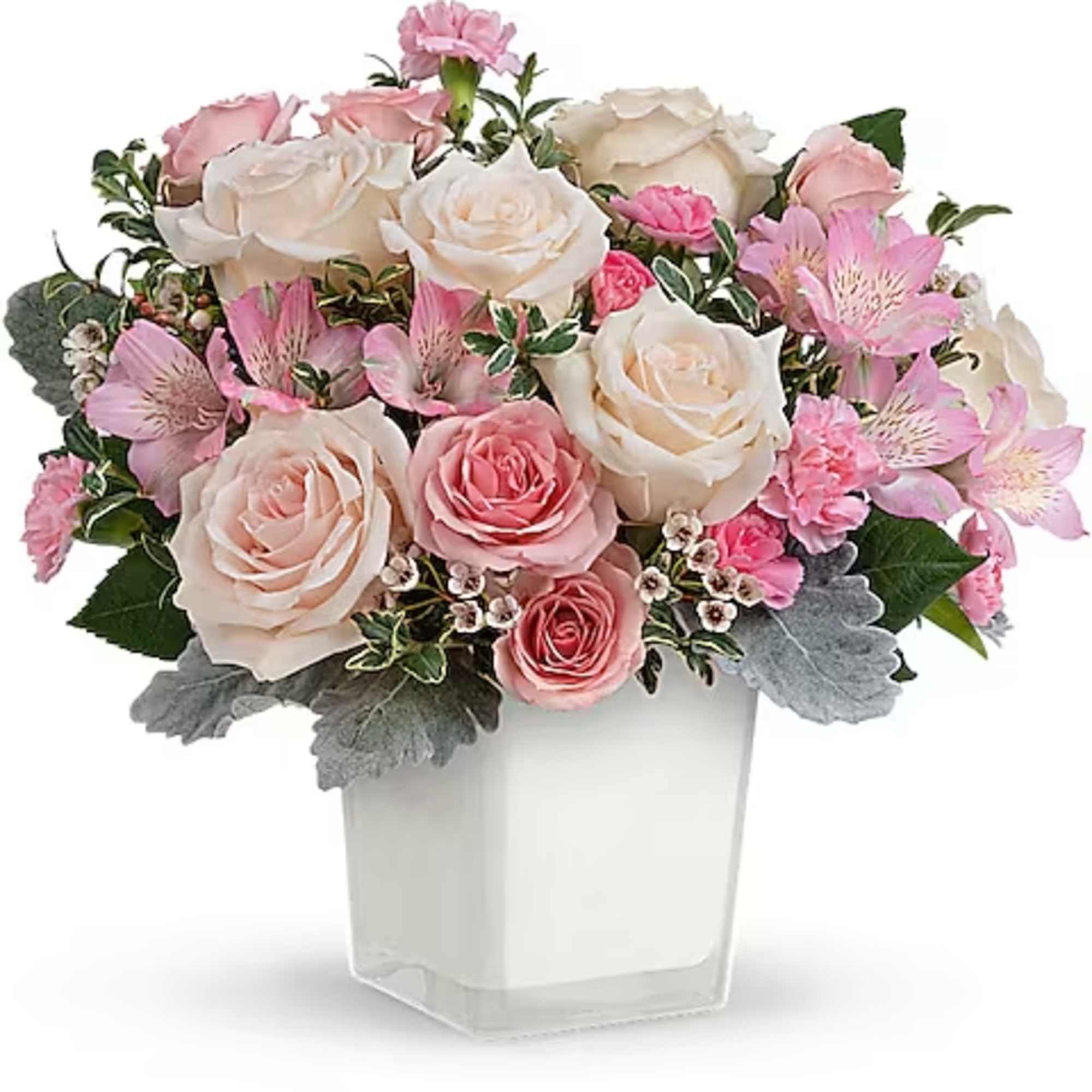 Pink and white rose bouquet in a clear square vase