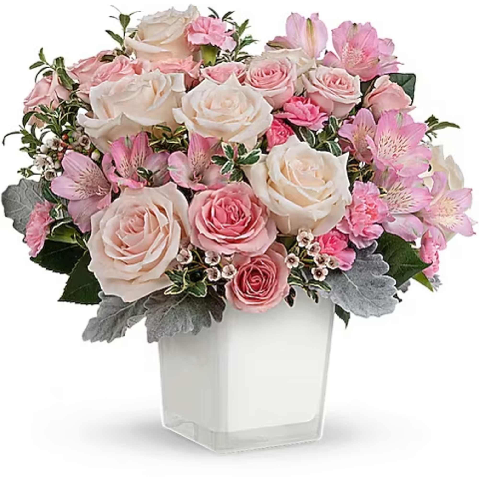 Pink and white rose bouquet in a clear square vase