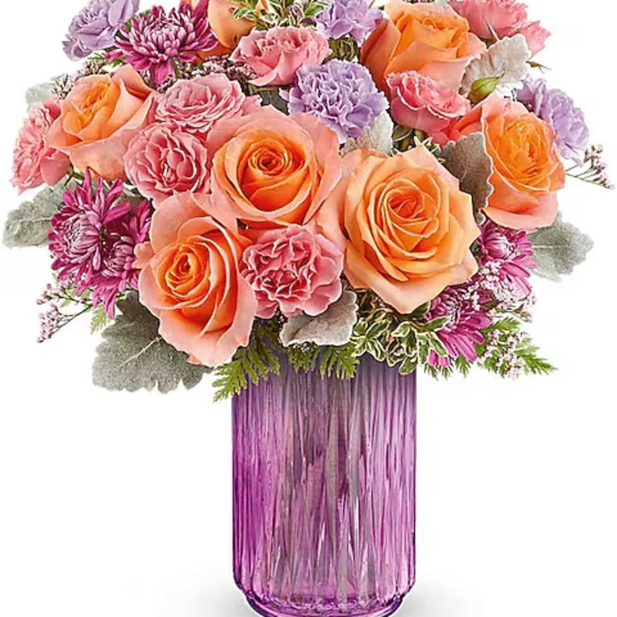 Bouquet of peach and pink roses in a purple glass vase