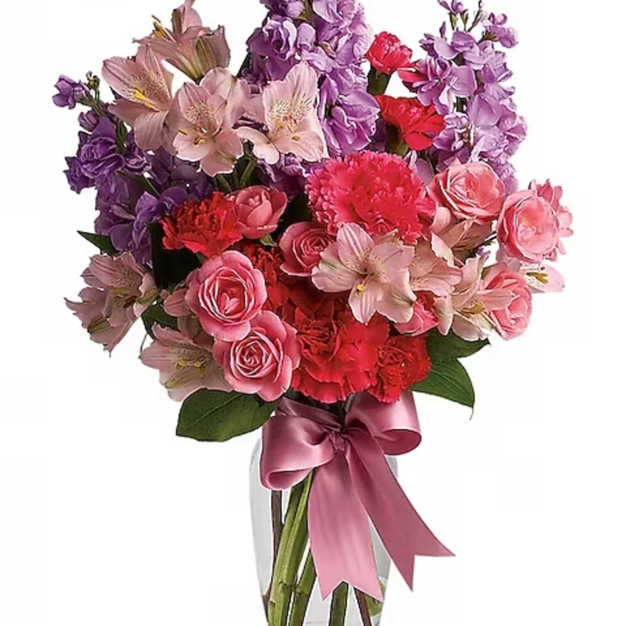 Pink and purple mixed bouquet in a clear glass vase with a satin ribbon