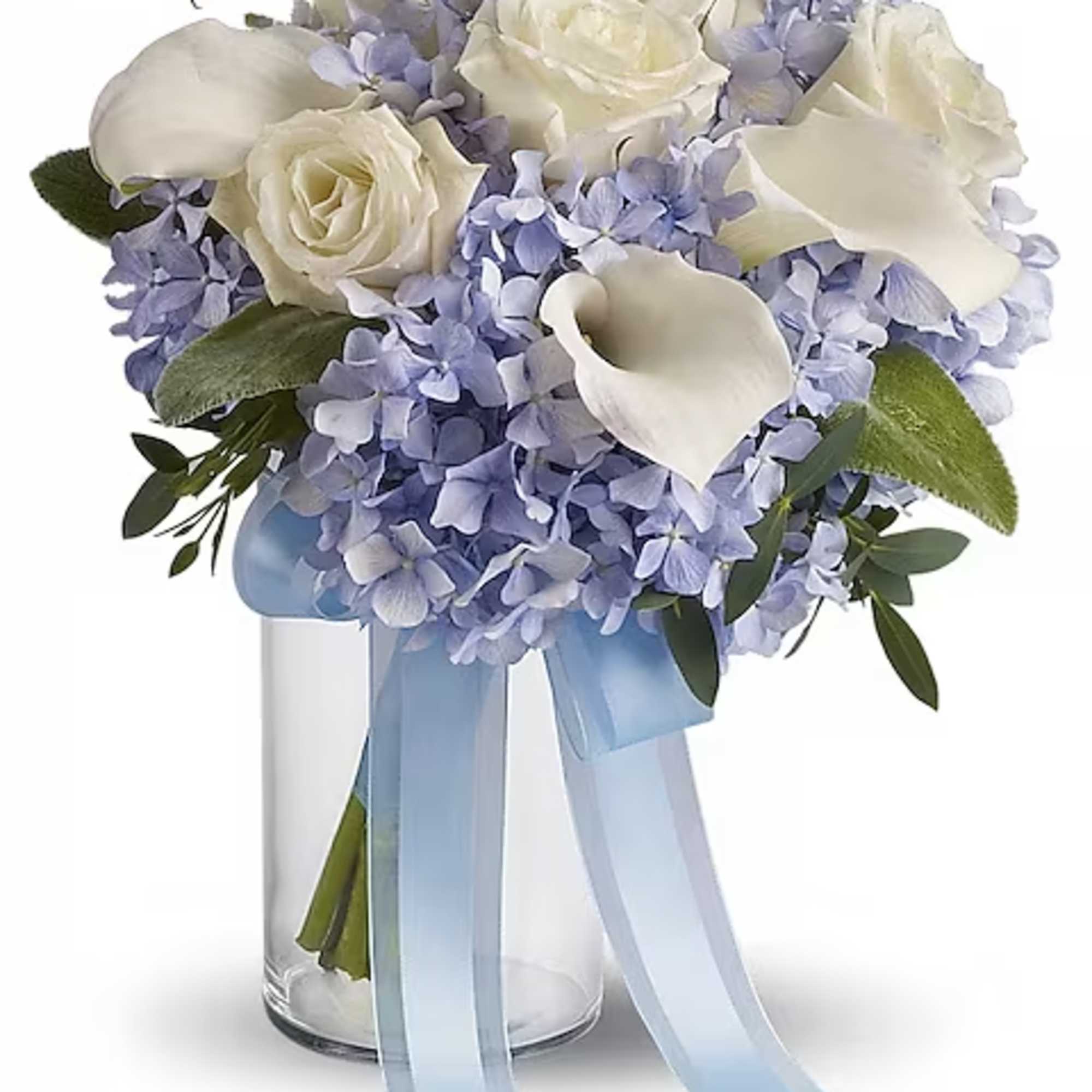 White roses and calla lilies in a glass vase with a blue ribbon