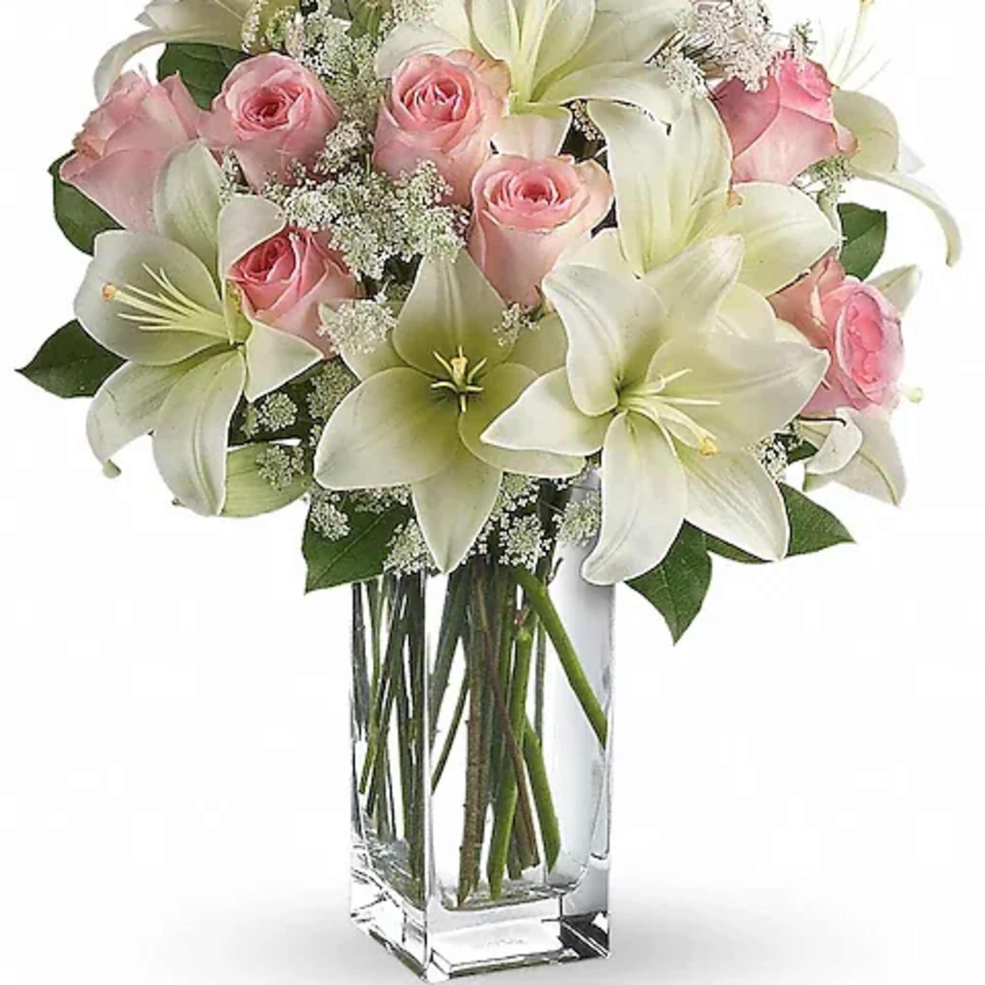 Pink roses and white lilies arranged in a clear glass vase