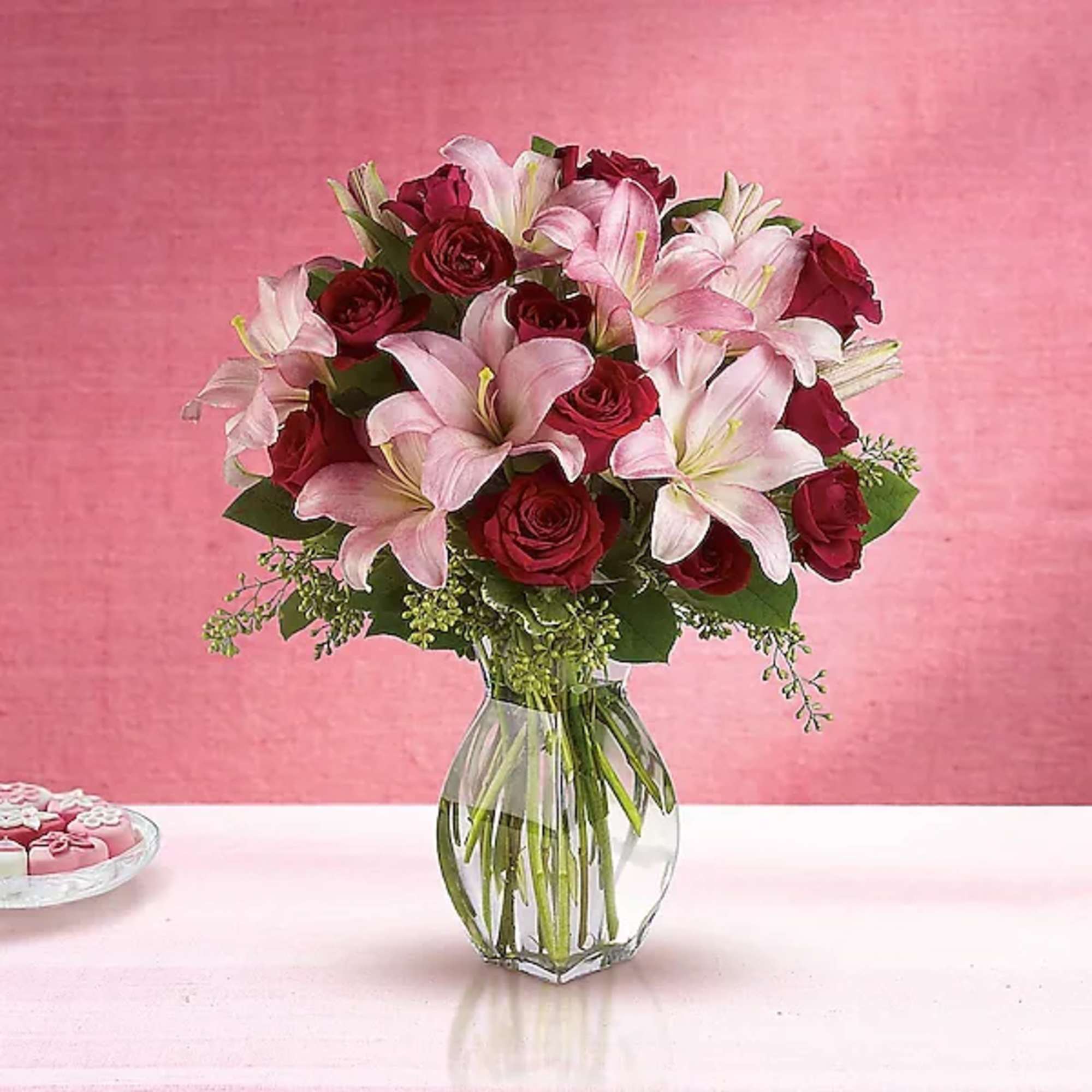 Bouquet of pink lilies and red roses in a clear glass vase, photo 2 of 2