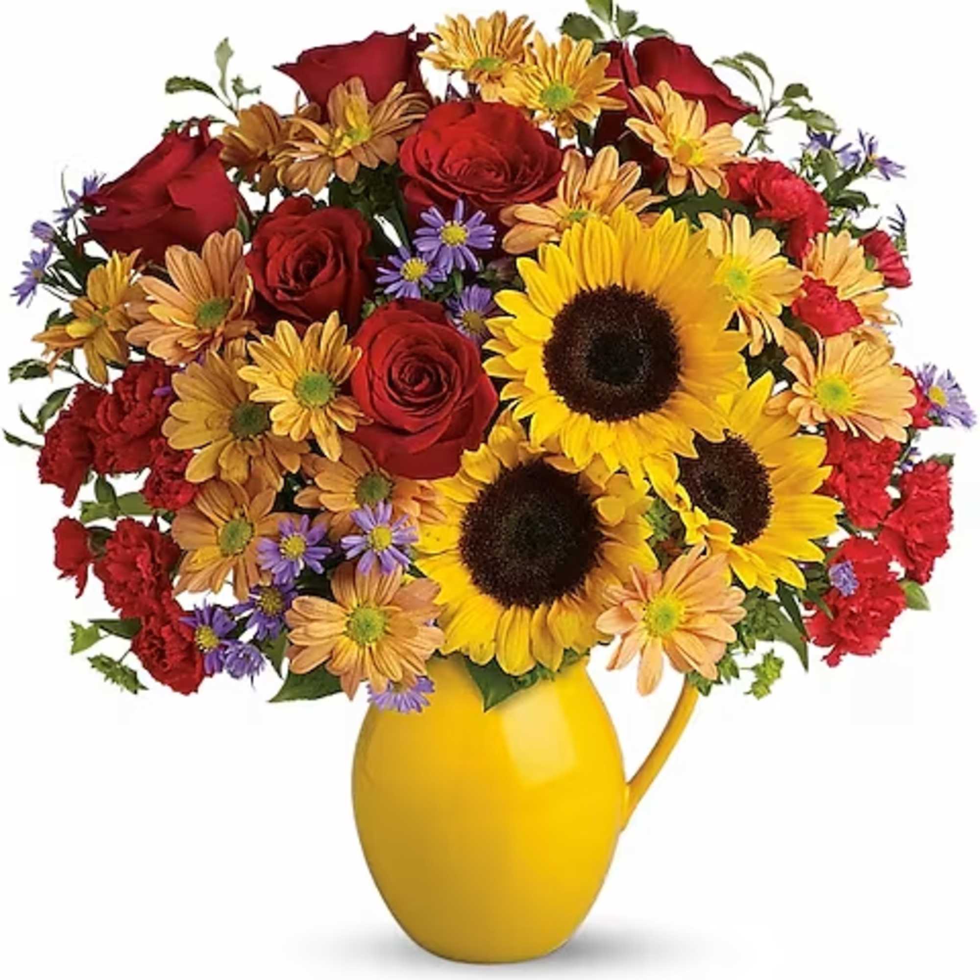 Bouquet of sunflowers, red roses, and mixed daisies in a yellow pitcher vase