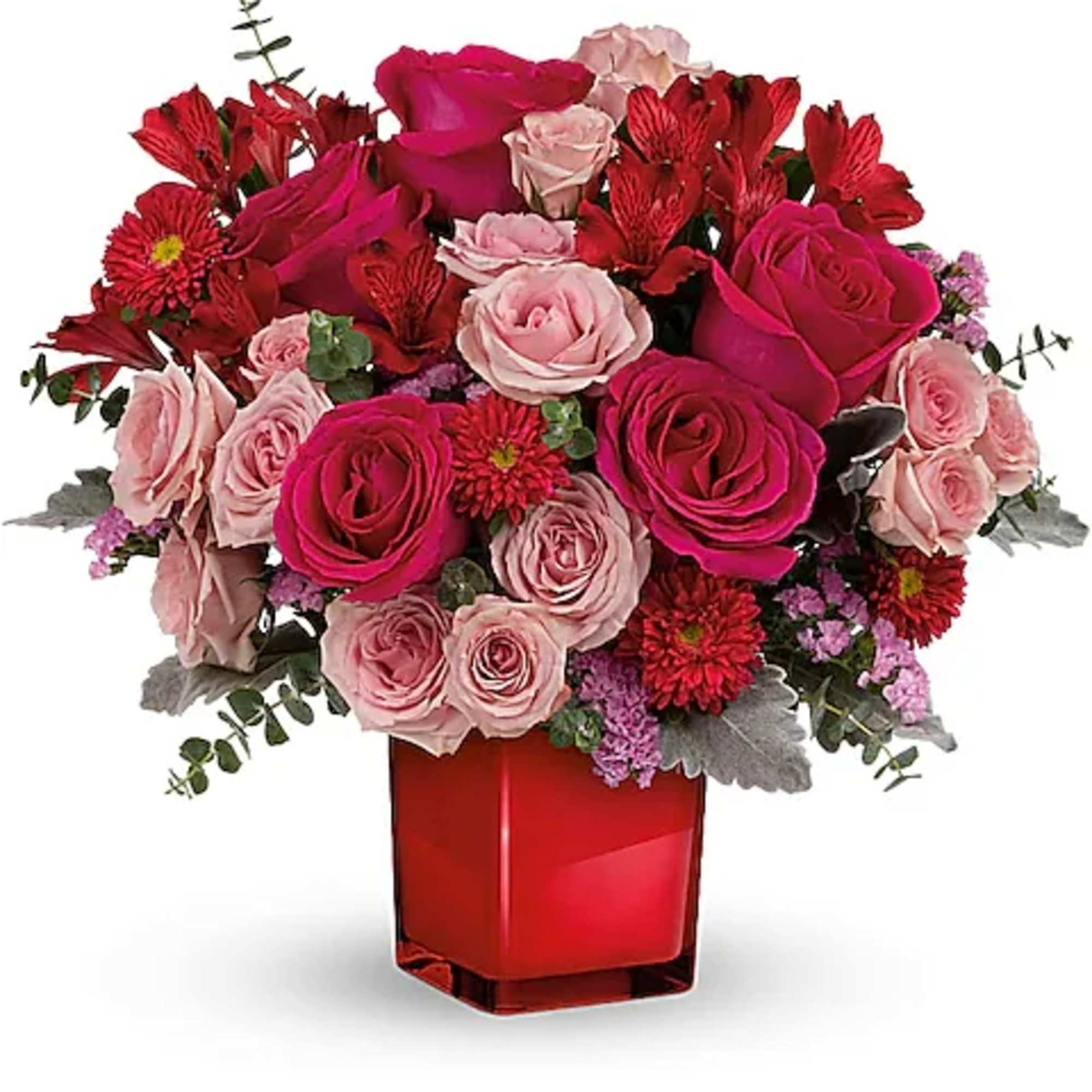 Pink and red rose bouquet in a red glass vase
