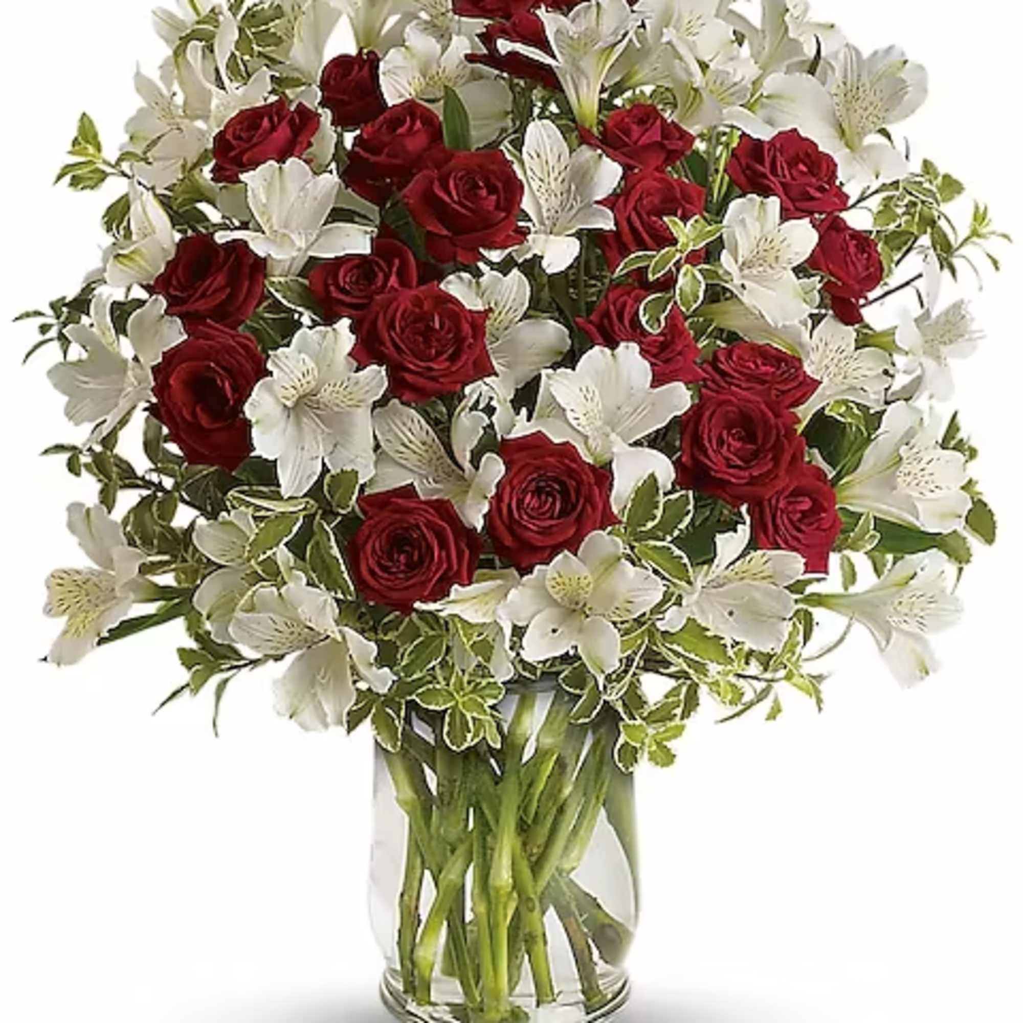 Red roses and white lilies in a clear glass vase