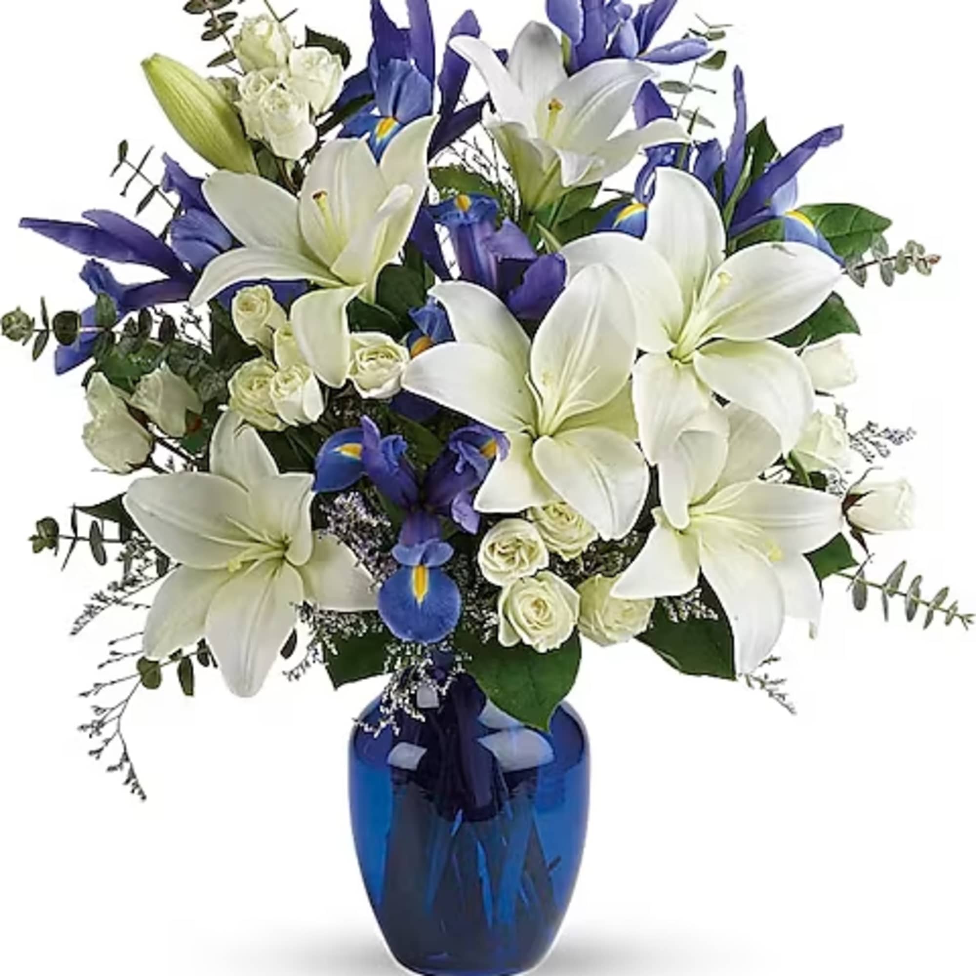 White lilies and blue irises arranged in a blue vase