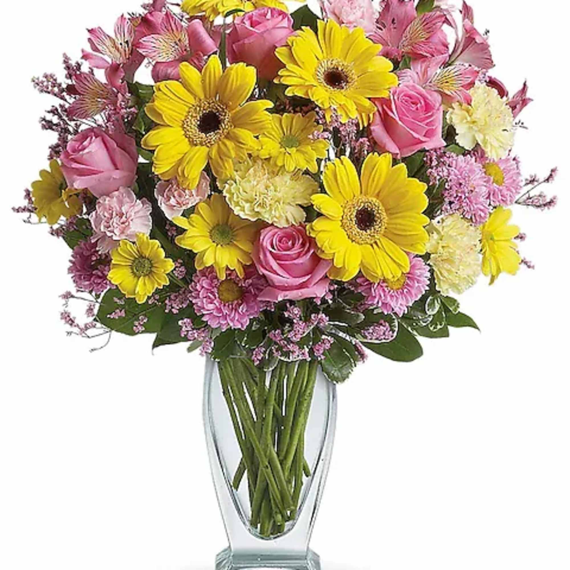 Pink roses and yellow daisies in a clear glass vase