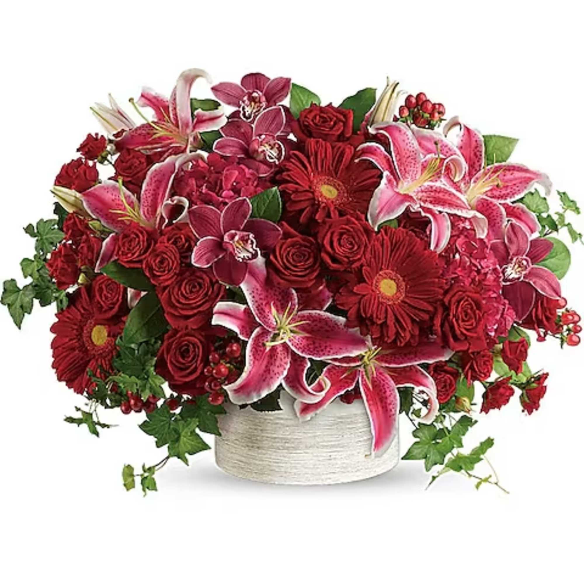 Red and pink floral arrangement in a white container