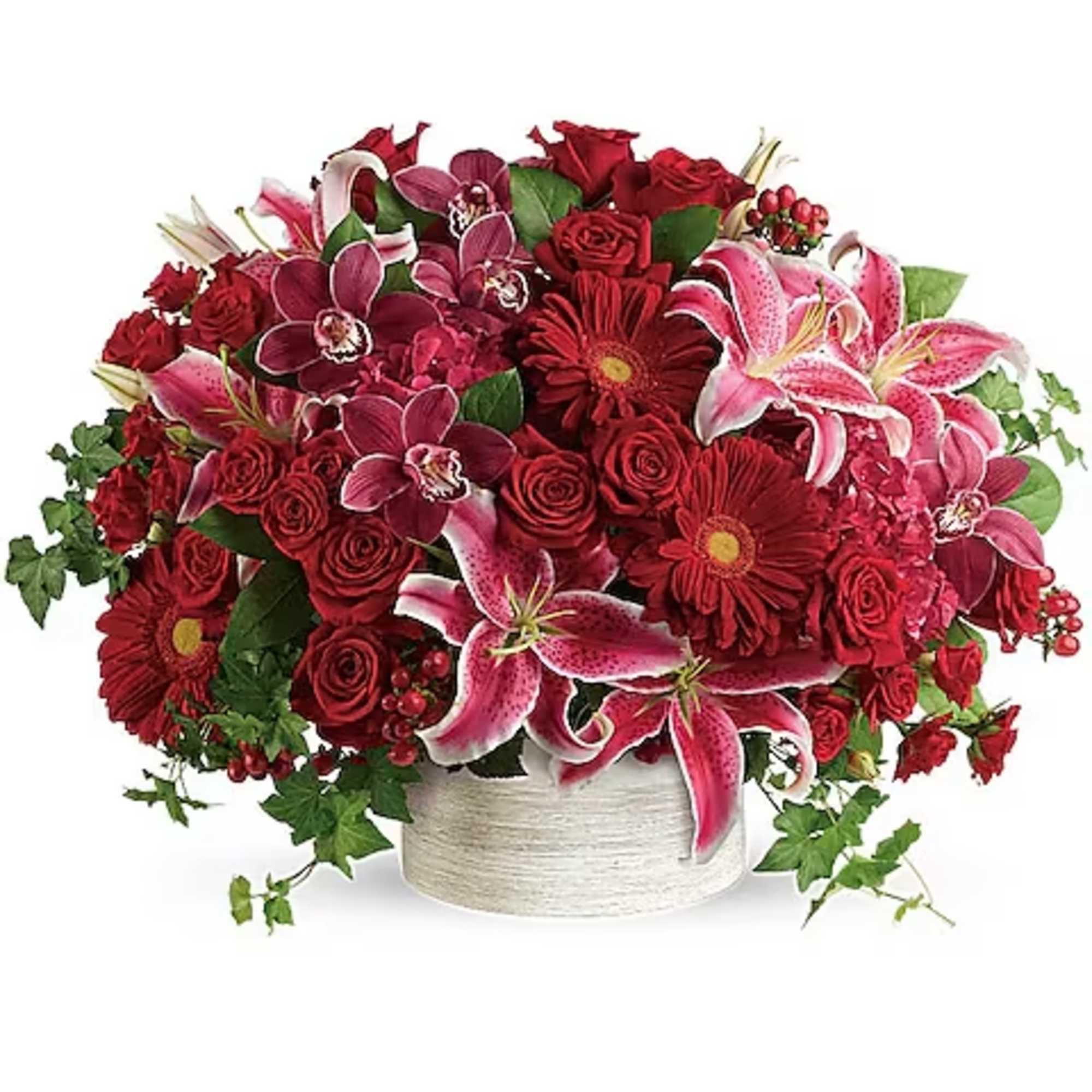 Red and pink floral arrangement in a white vase