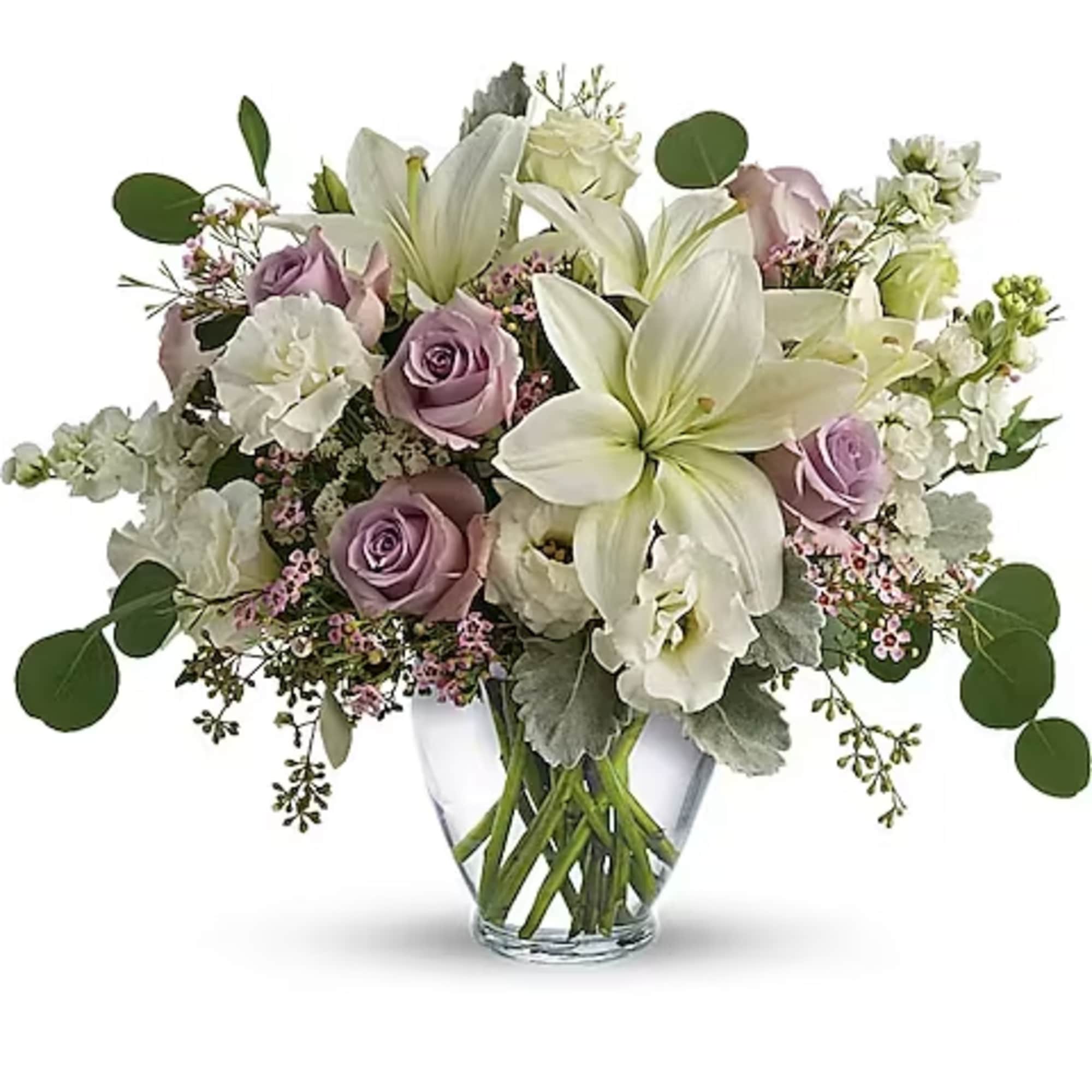 White lilies and lavender roses in a clear glass vase