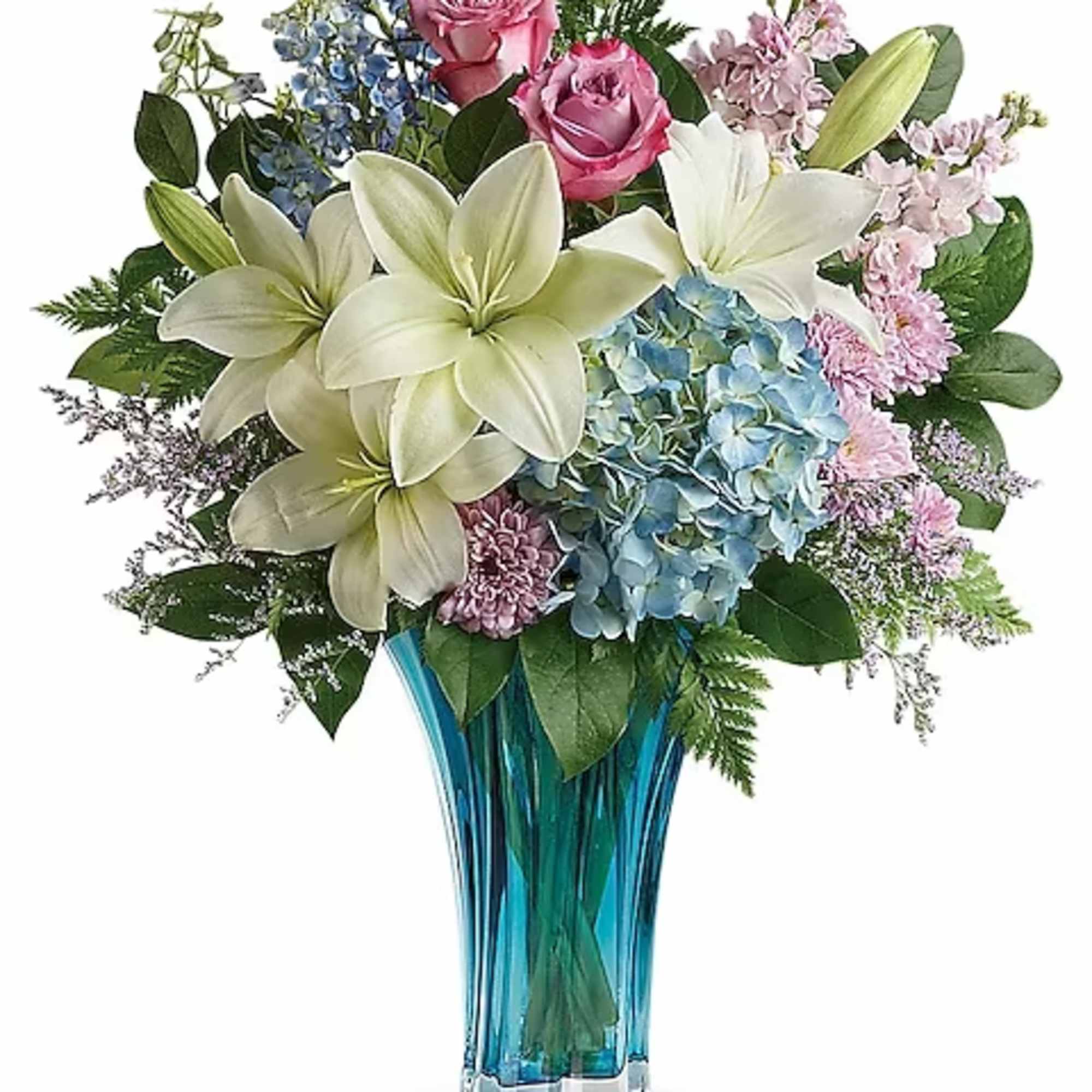 Bouquet of lilies, roses, hydrangeas, and blue flowers in a blue glass vase