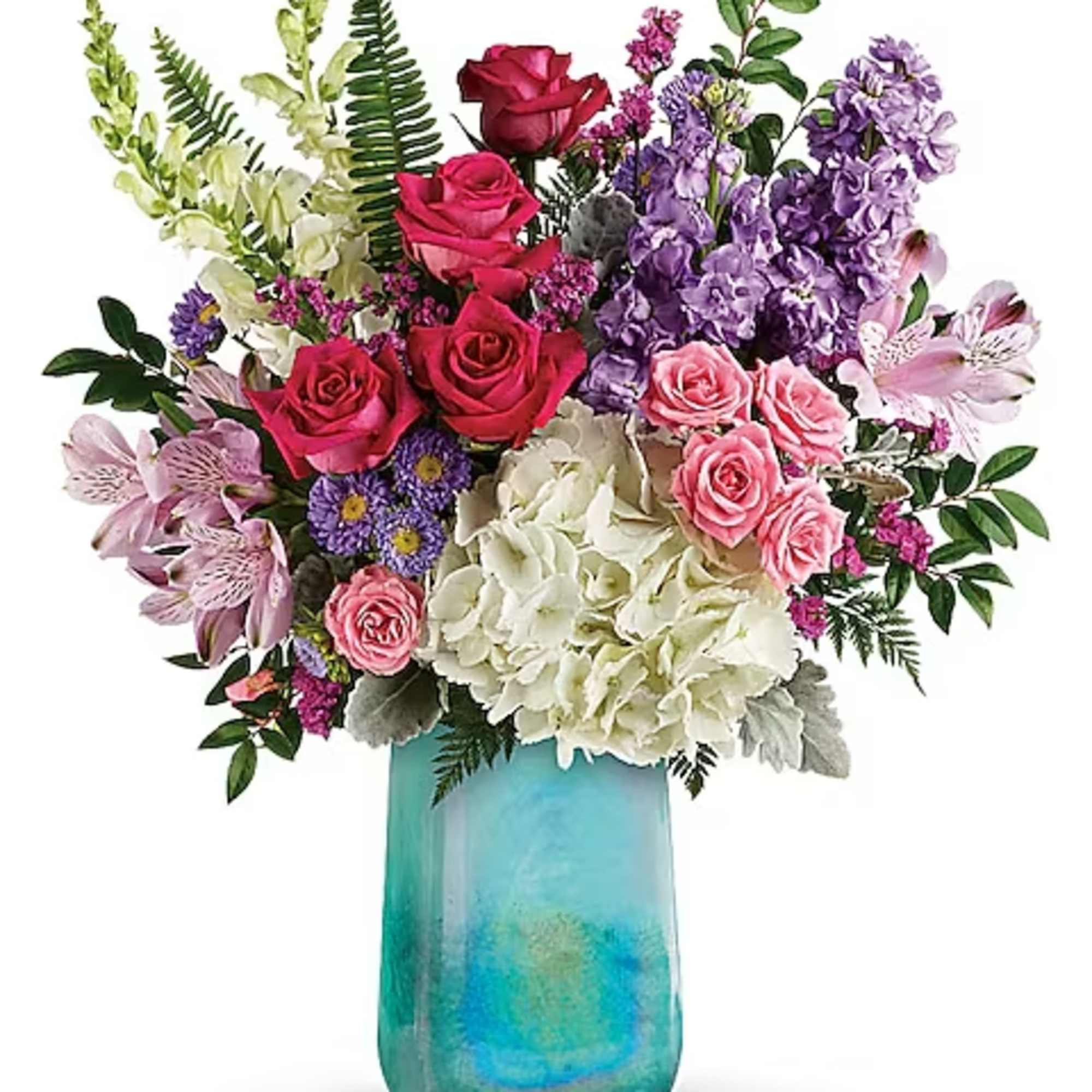 Mixed bouquet of roses, hydrangeas, and purple blooms in a turquoise vase