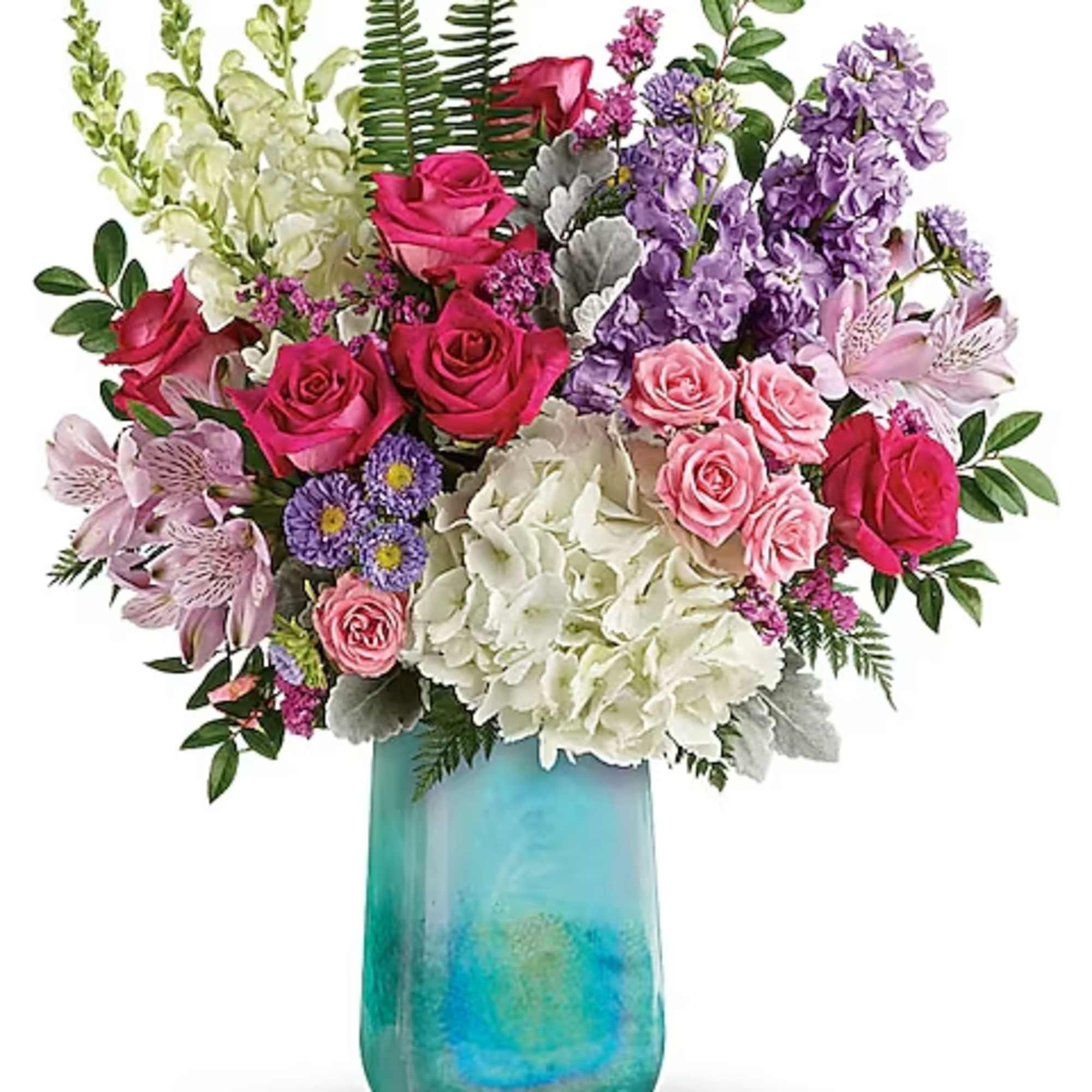 Mixed bouquet of roses, hydrangeas, and purple blooms in a turquoise vase