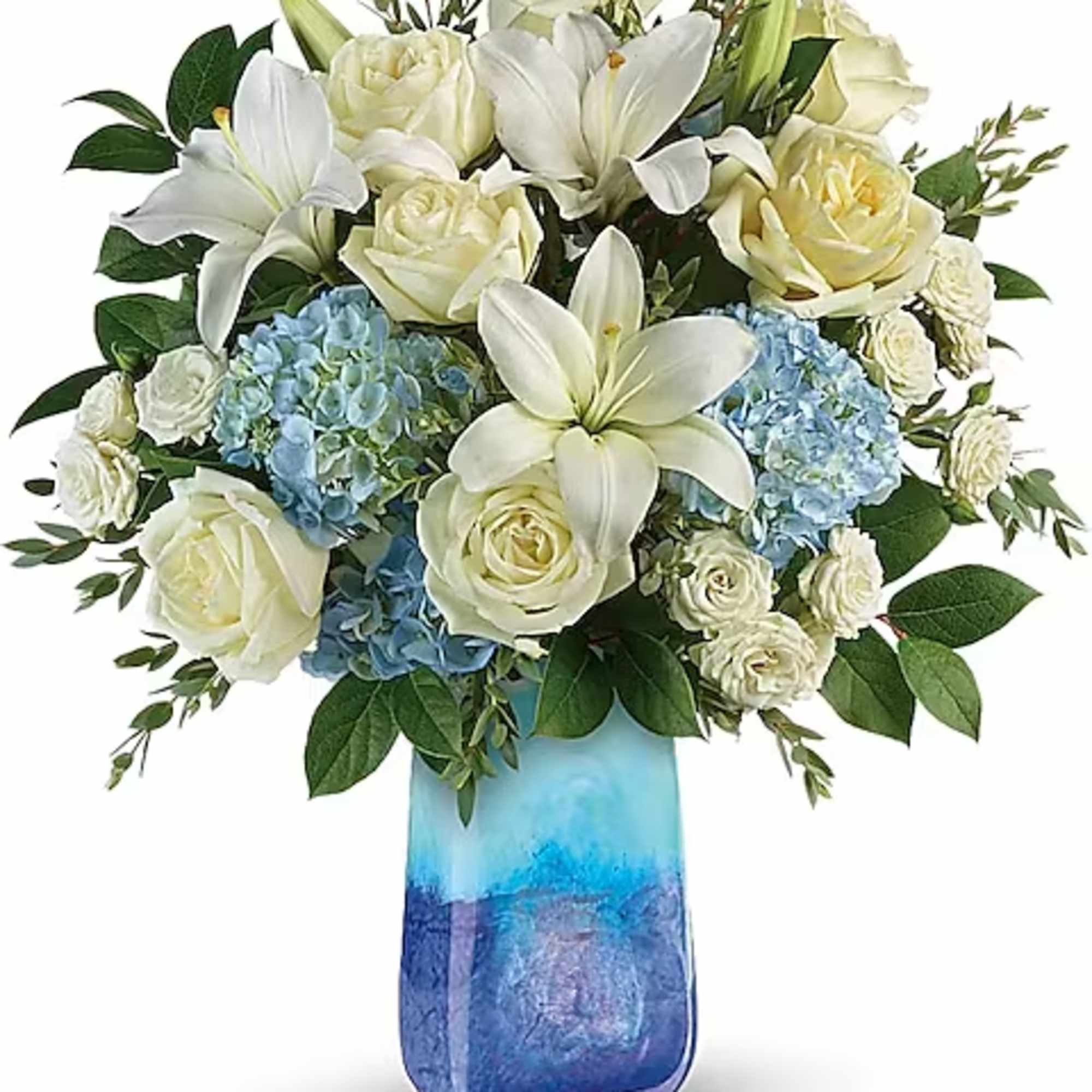 White lilies and roses with blue hydrangeas in a blue vase