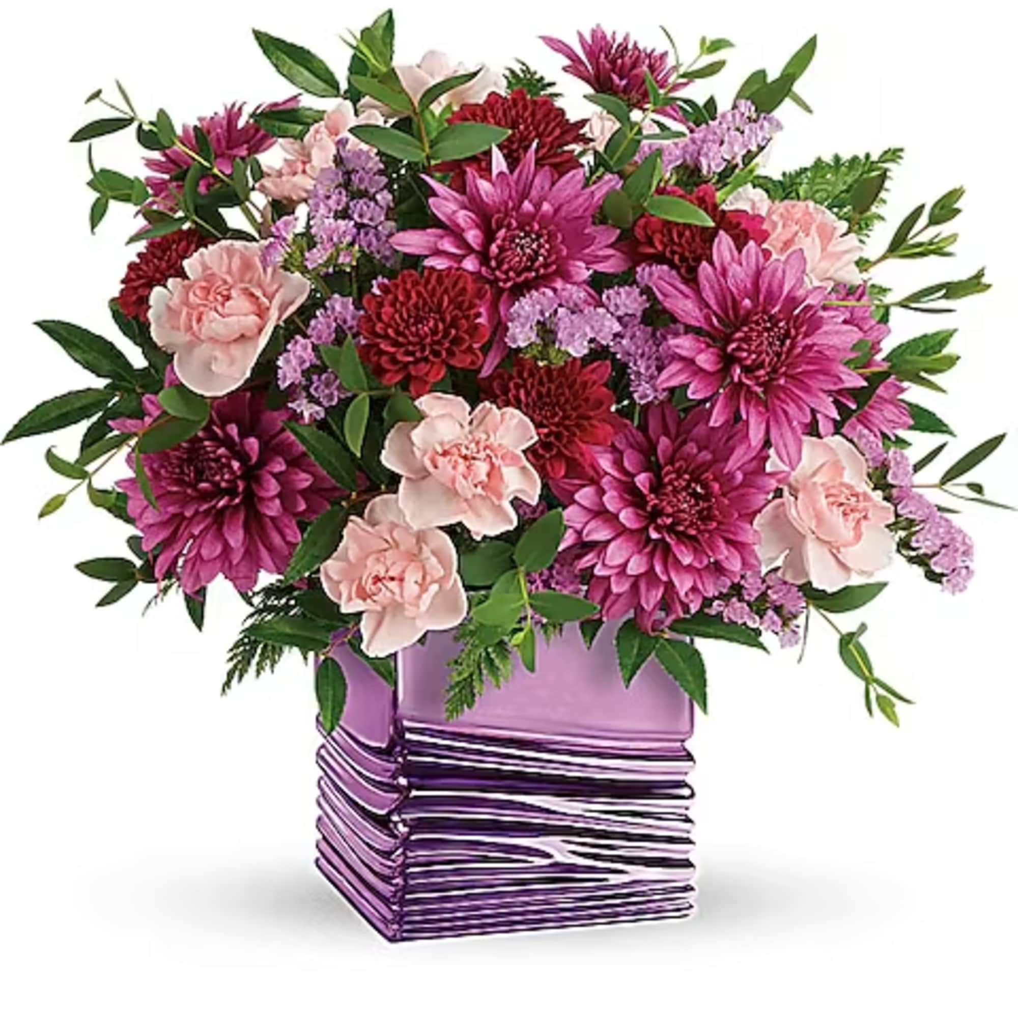 Pink and purple flower arrangement in a purple glass vase