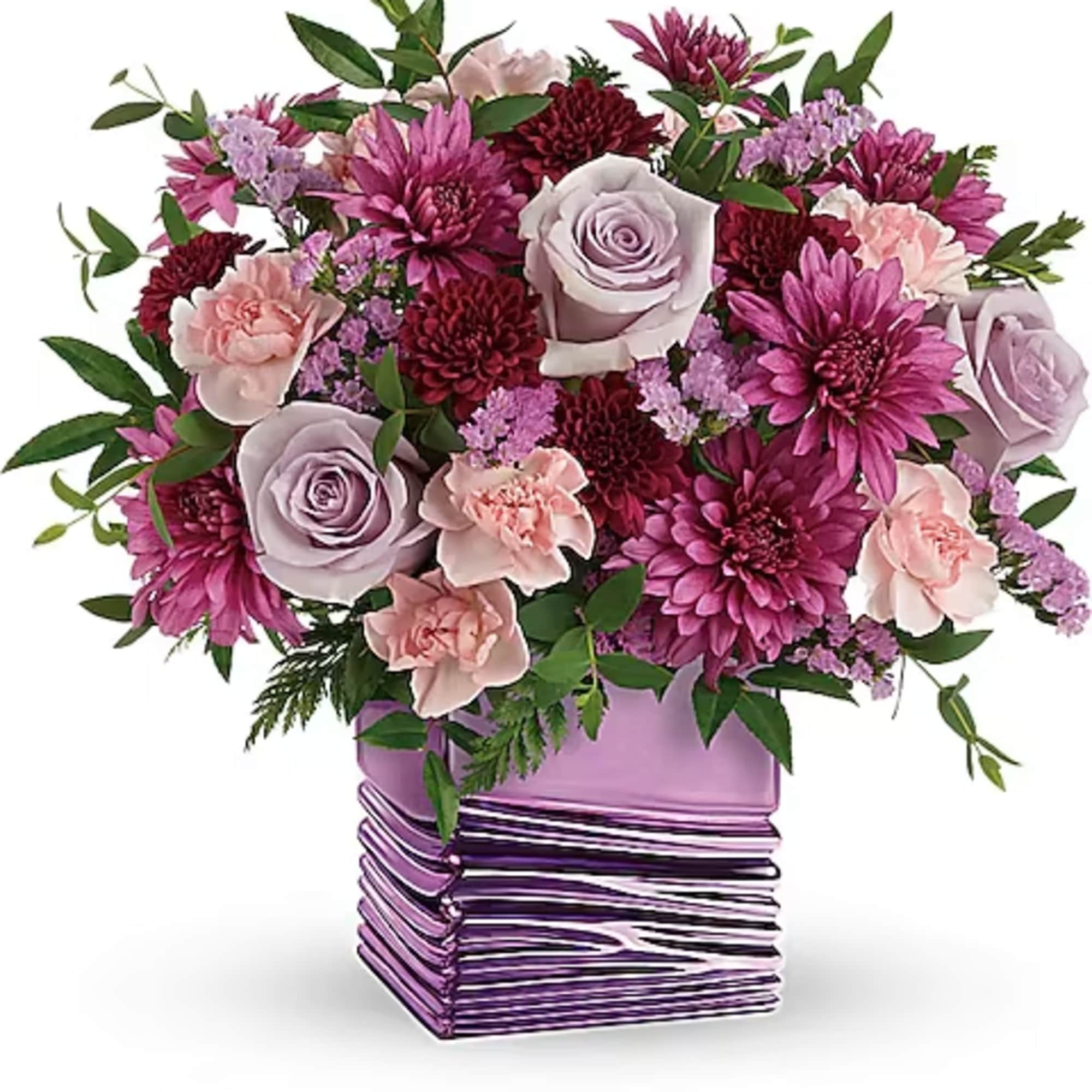 Bouquet of pink and lavender flowers in a purple vase