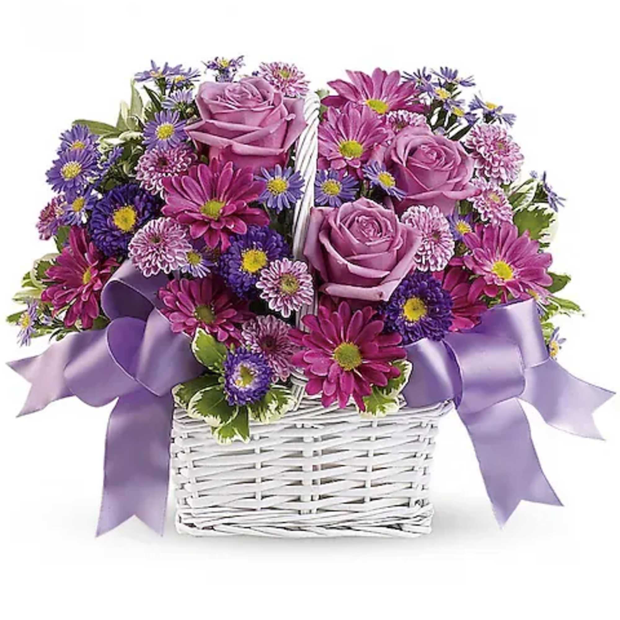 Lavender roses and purple daisies in a white basket with a ribbon