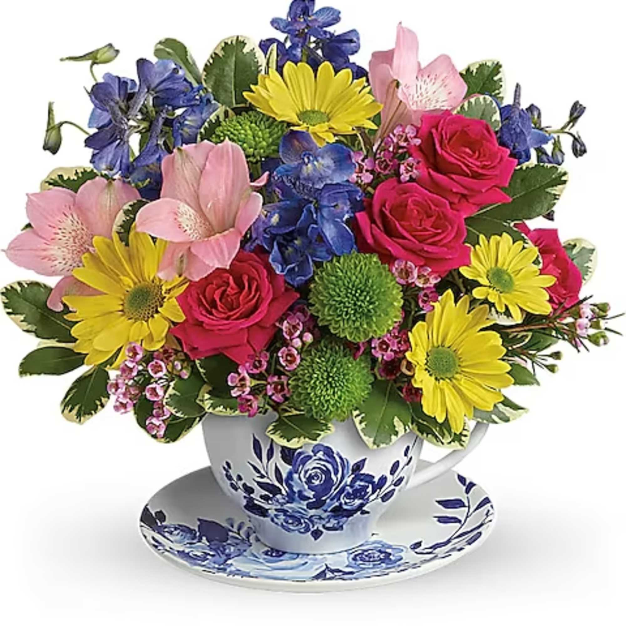 Colorful mixed bouquet in a blue-and-white teacup and saucer