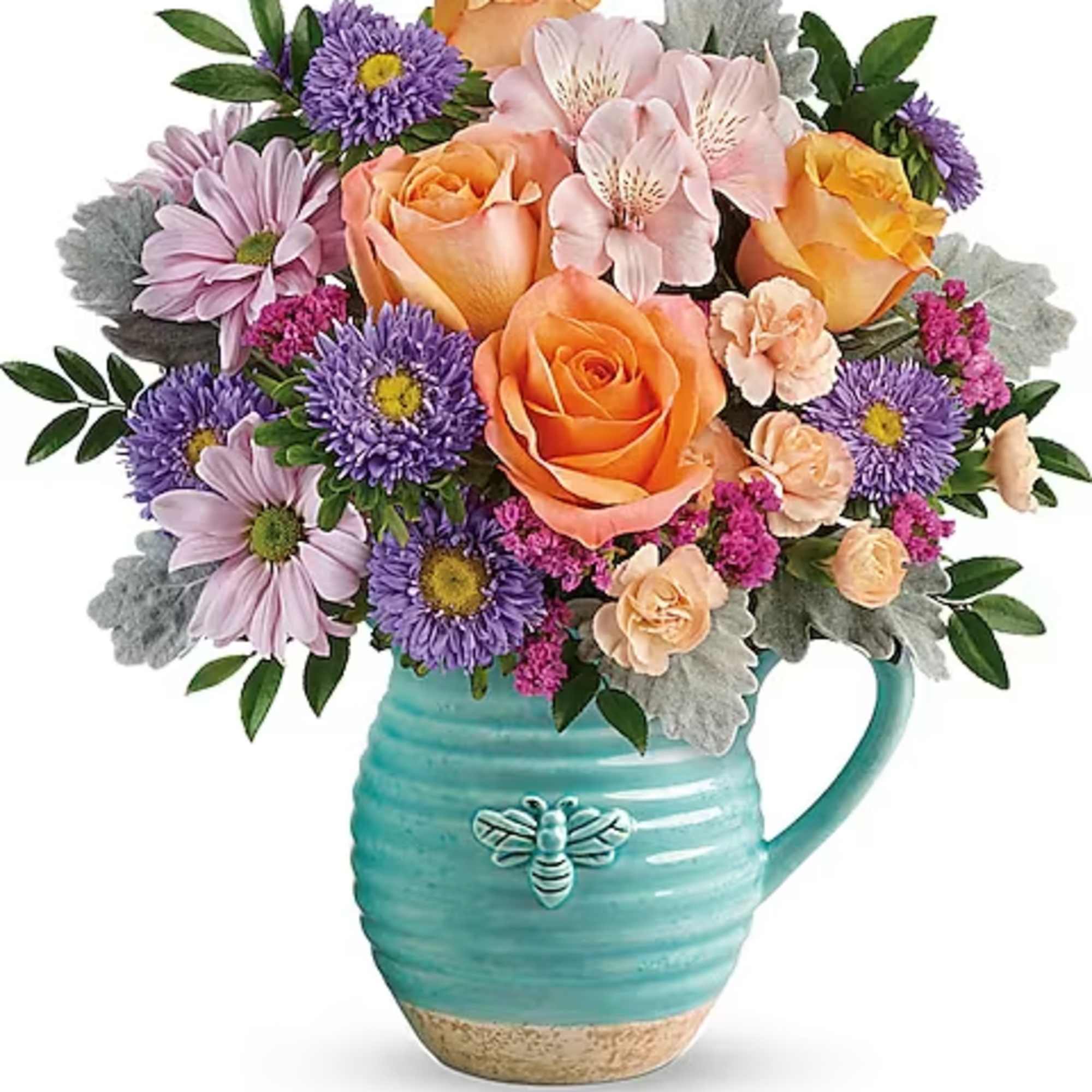 Bouquet of orange and lavender flowers in a turquoise mug vase