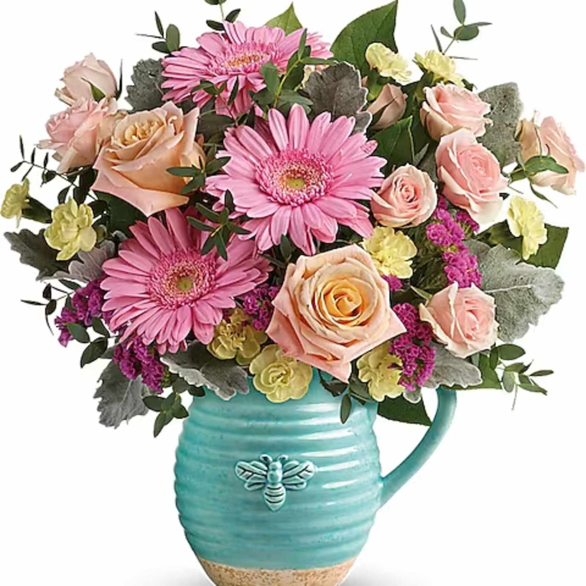Pink gerbera daisies and roses in a turquoise pitcher vase