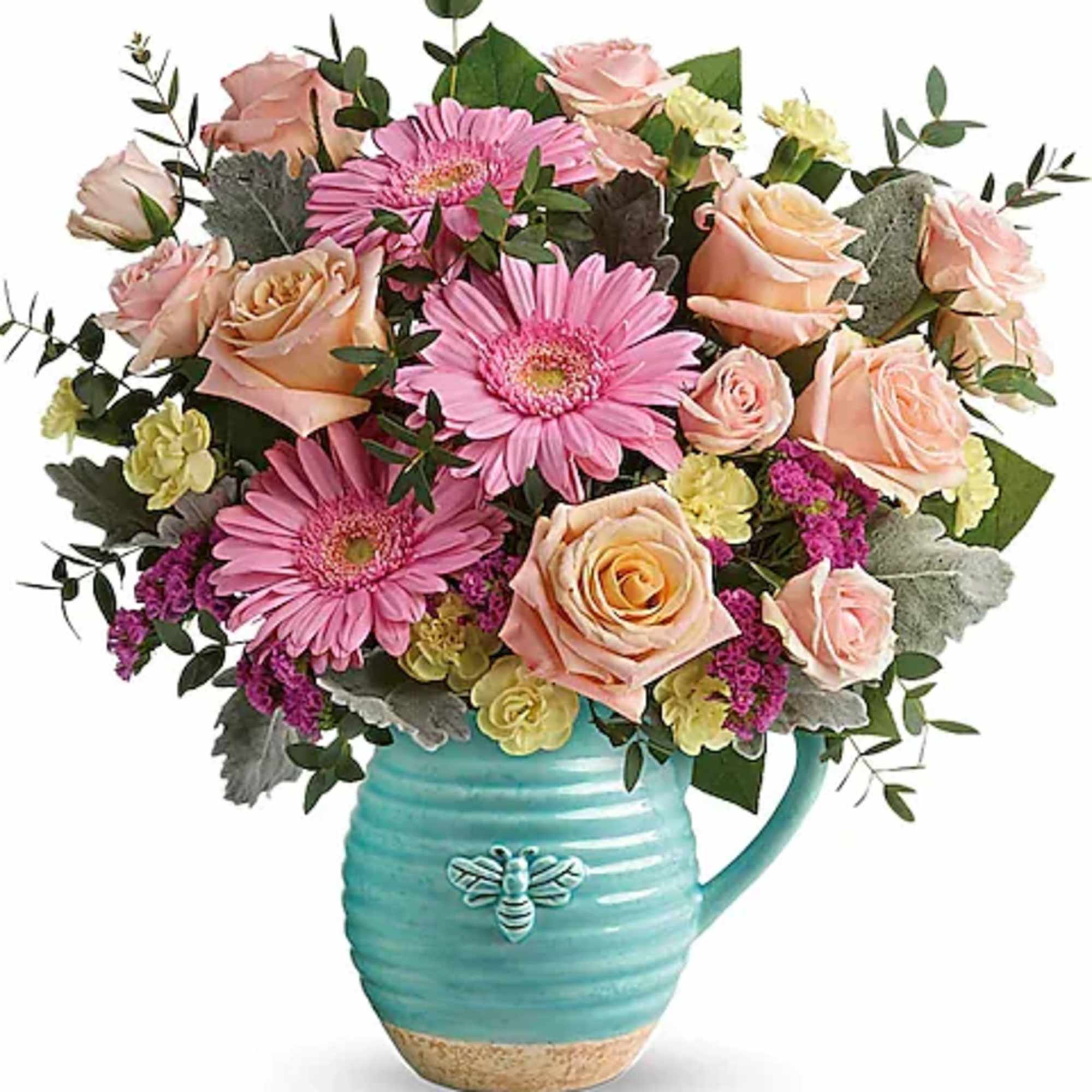 Pink gerbera daisies and peach roses in a turquoise pitcher vase
