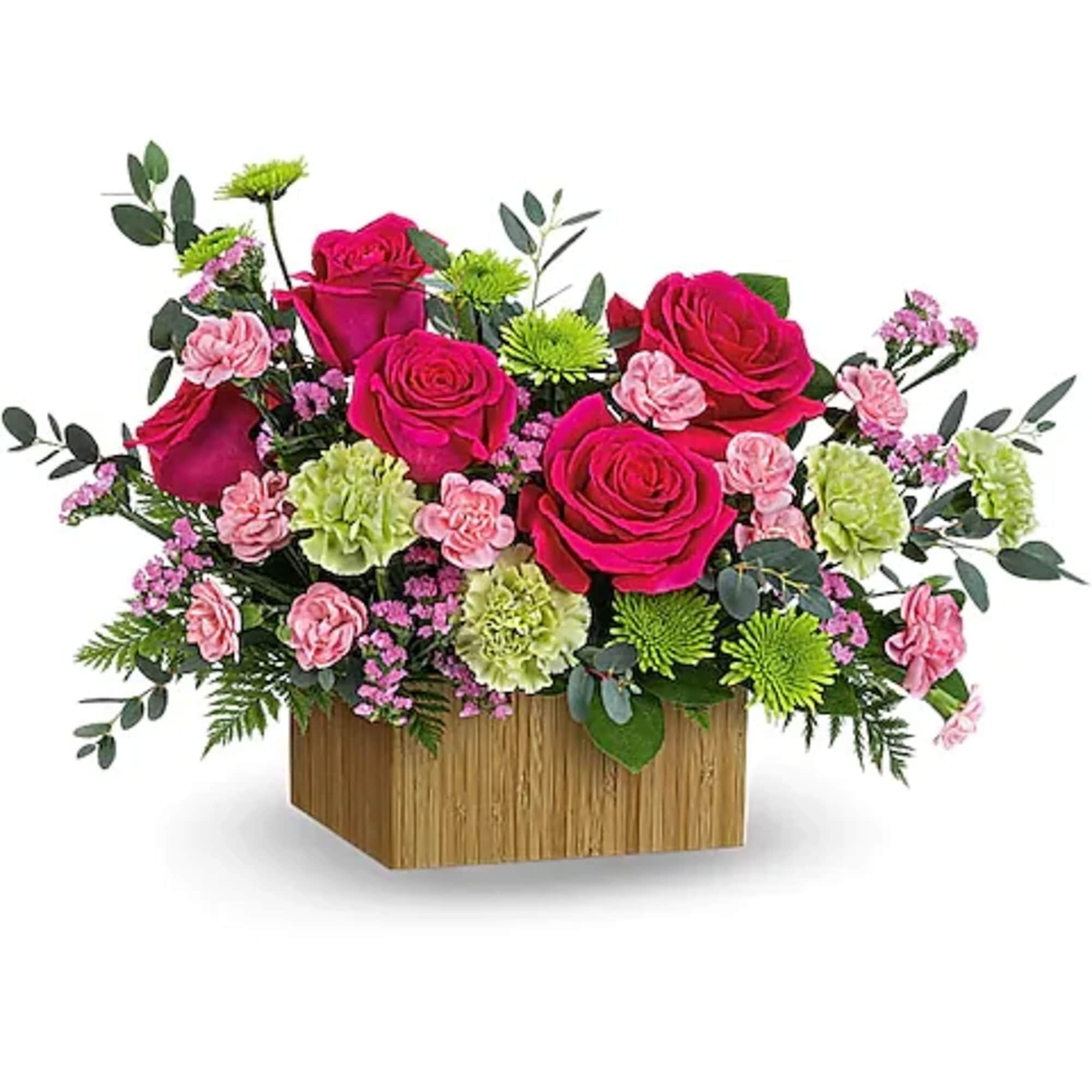Pink roses and carnations in a wooden box arrangement