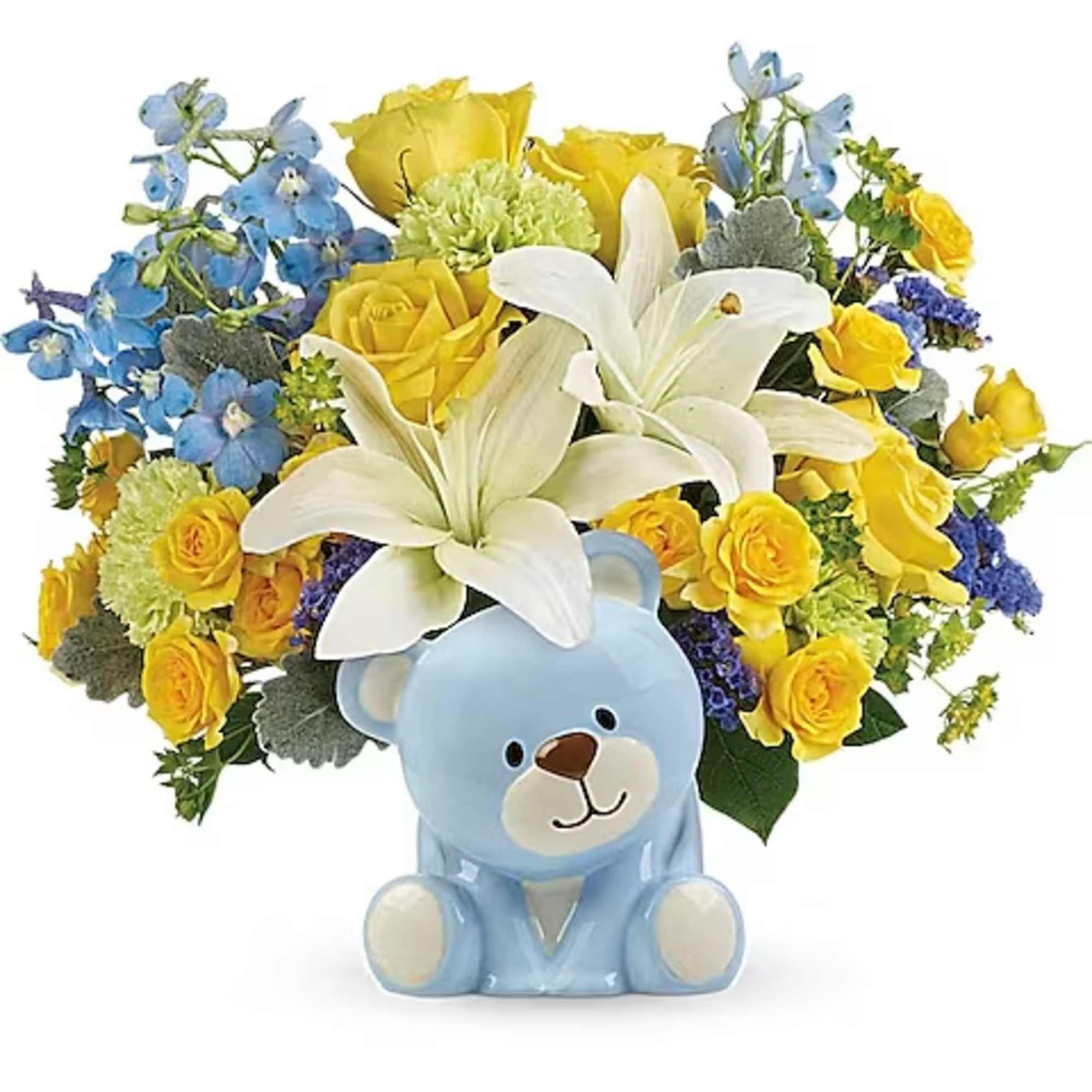 Yellow roses and white lilies arranged with a blue teddy bear figurine