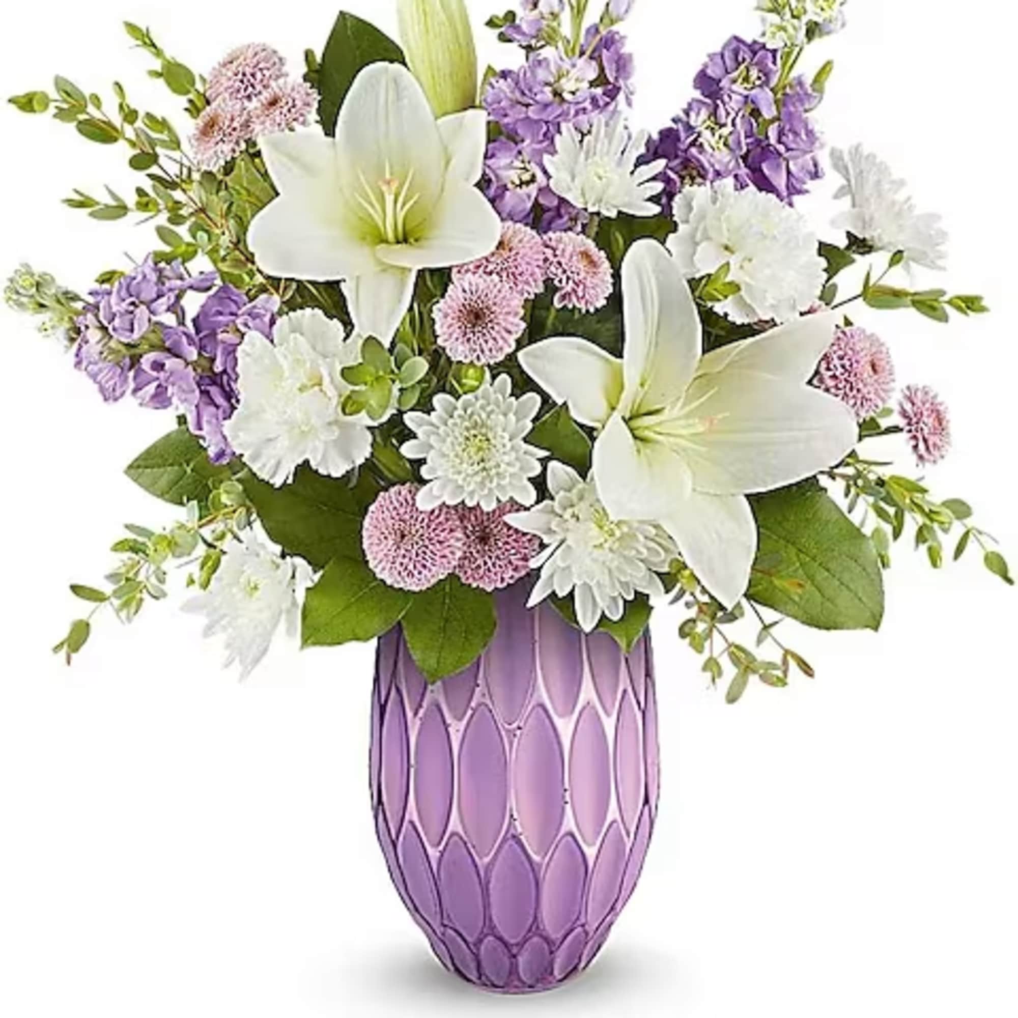 White lilies and purple flowers arranged in a lavender vase