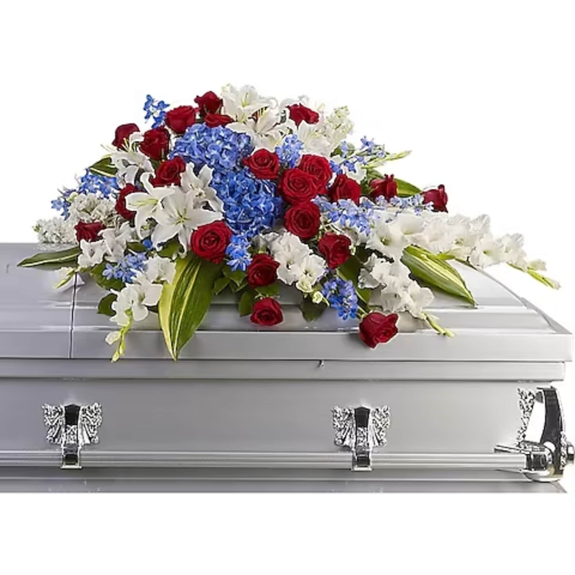 Red roses, white lilies, and blue flowers arranged on a silver casket