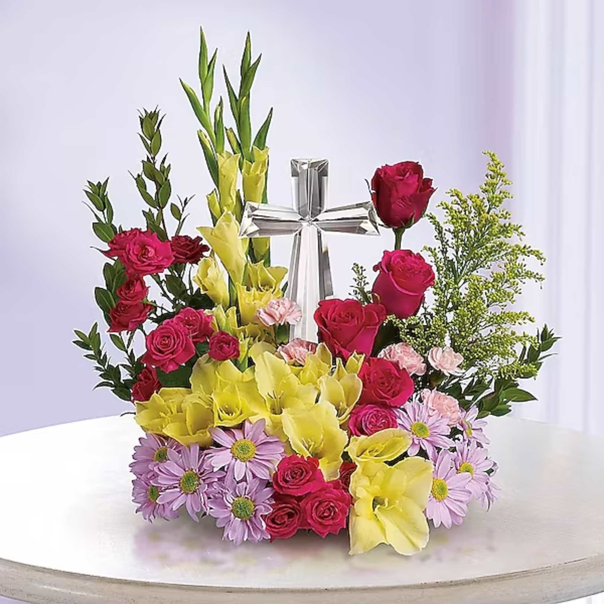 Mixed bouquet with roses, yellow calla lilies, and a silver cross