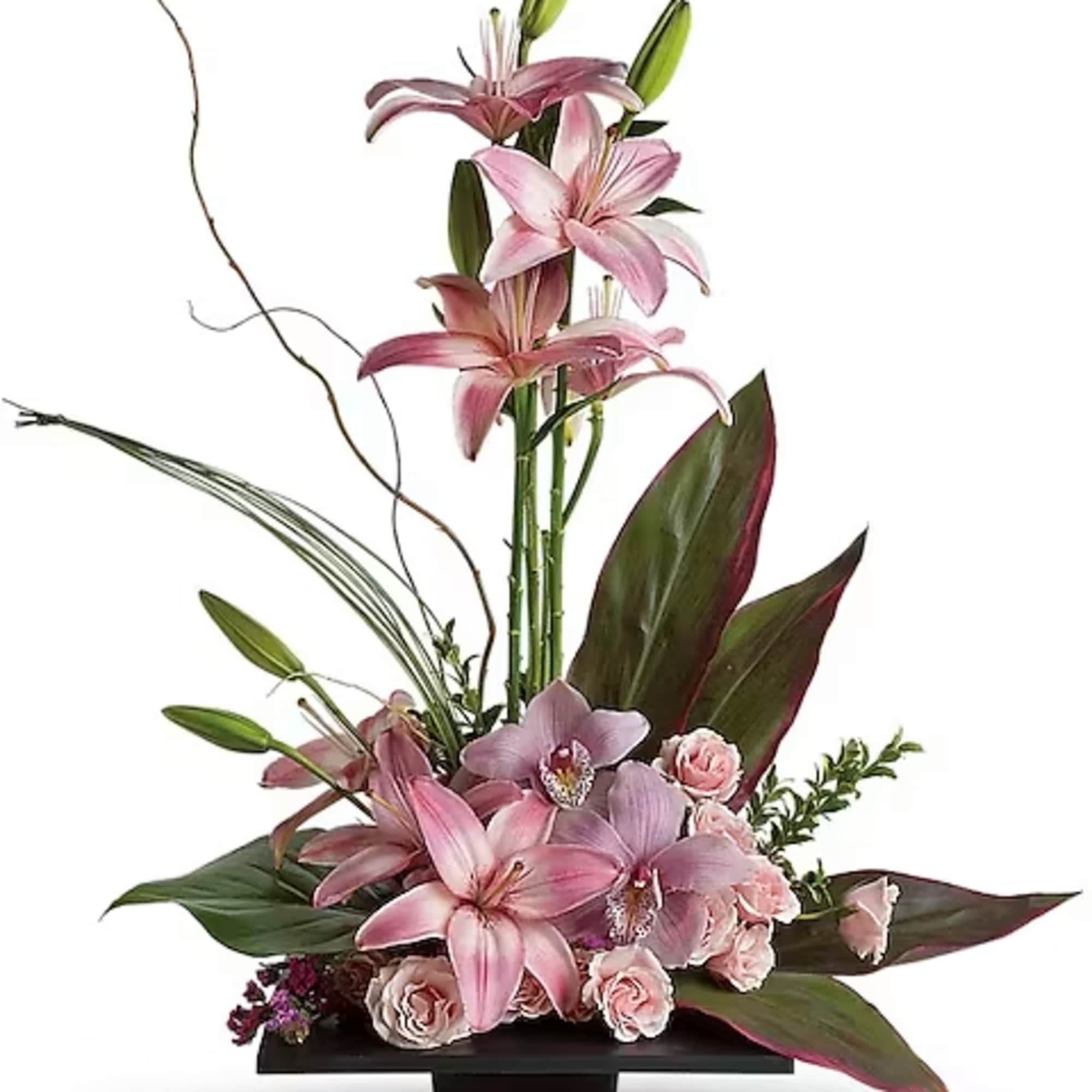 Tall pink lily and orchid arrangement in a black vase