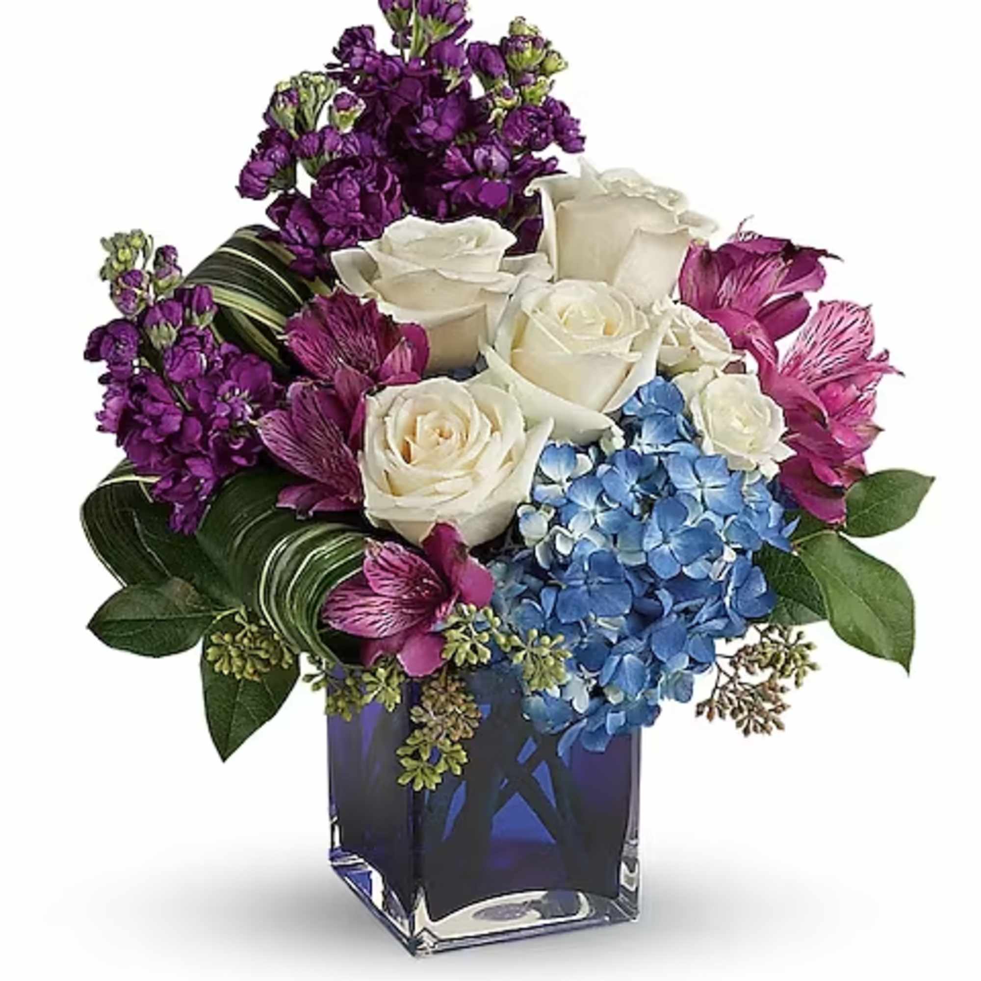 Bouquet of white roses, blue hydrangeas, and purple flowers in a blue glass vase
