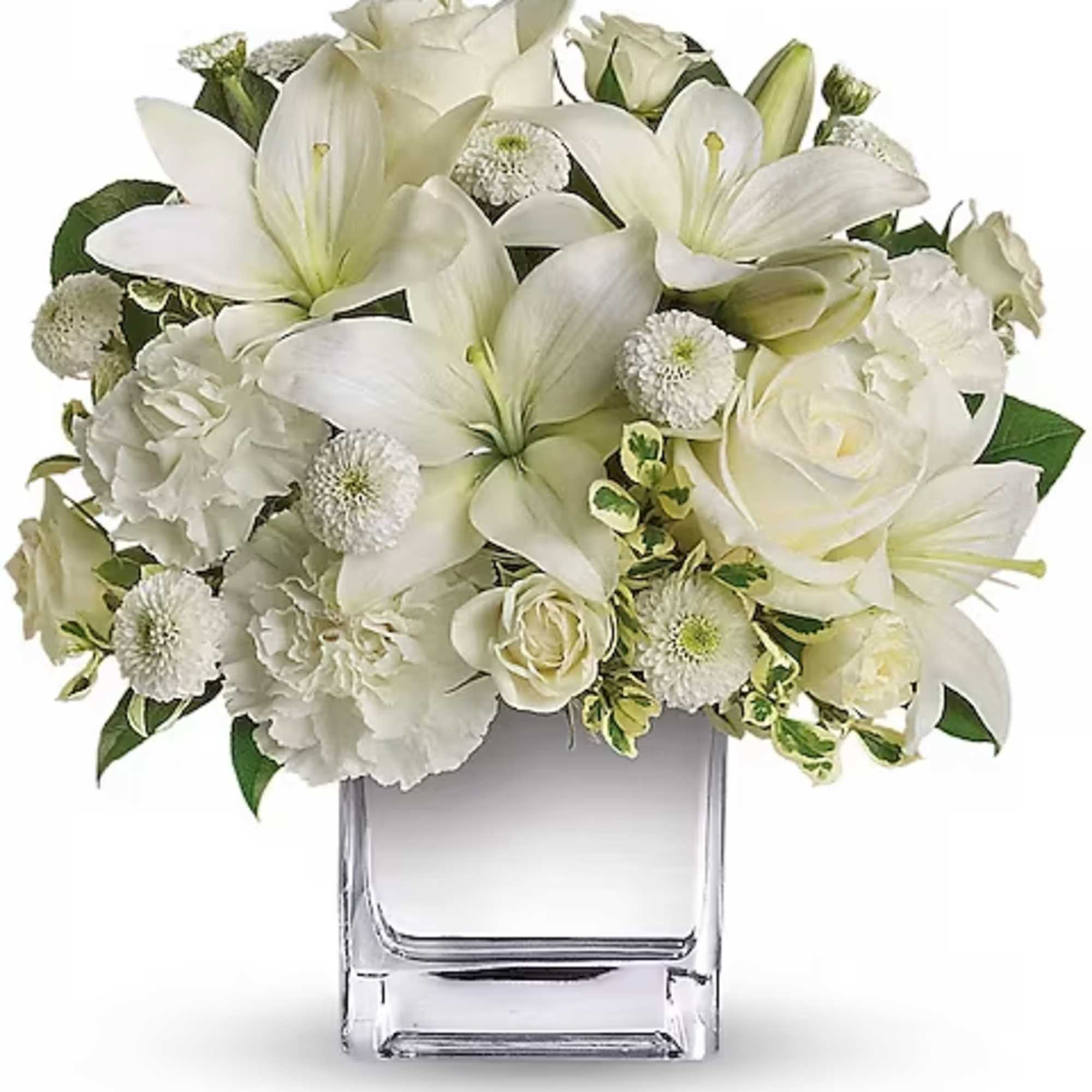 White lilies and roses arranged in a clear glass vase