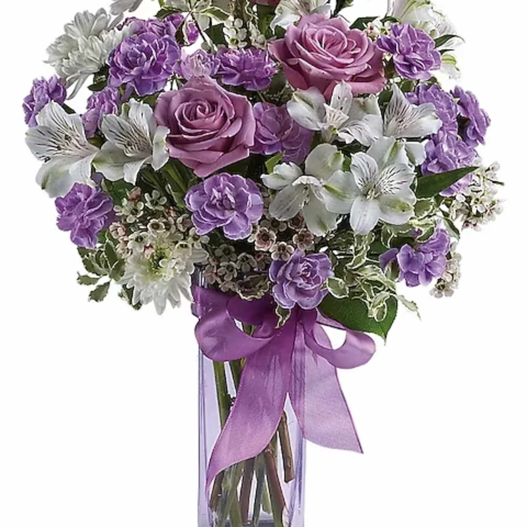 Purple roses and white flowers in a clear glass vase with a purple ribbon