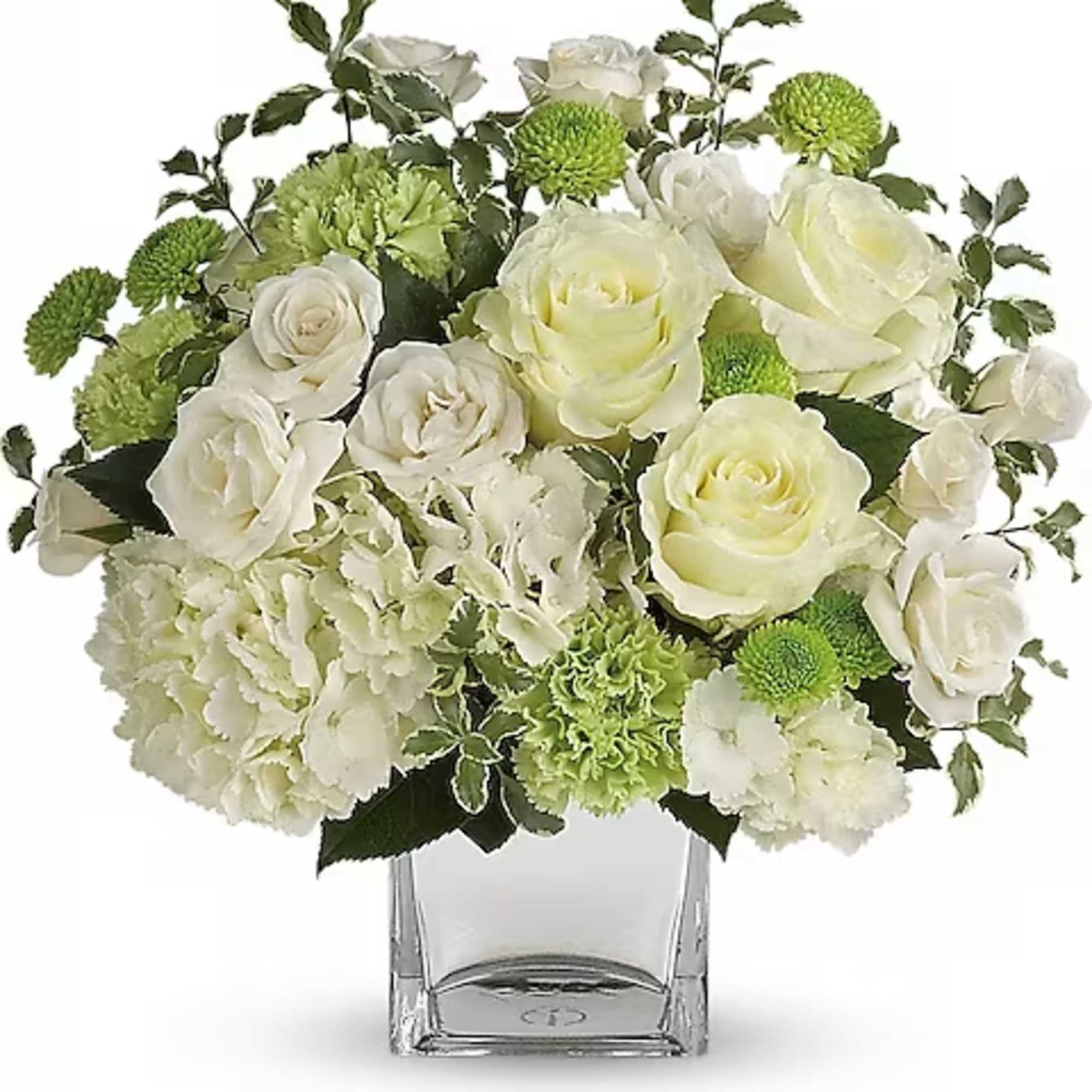 White roses and green carnations in a clear glass vase