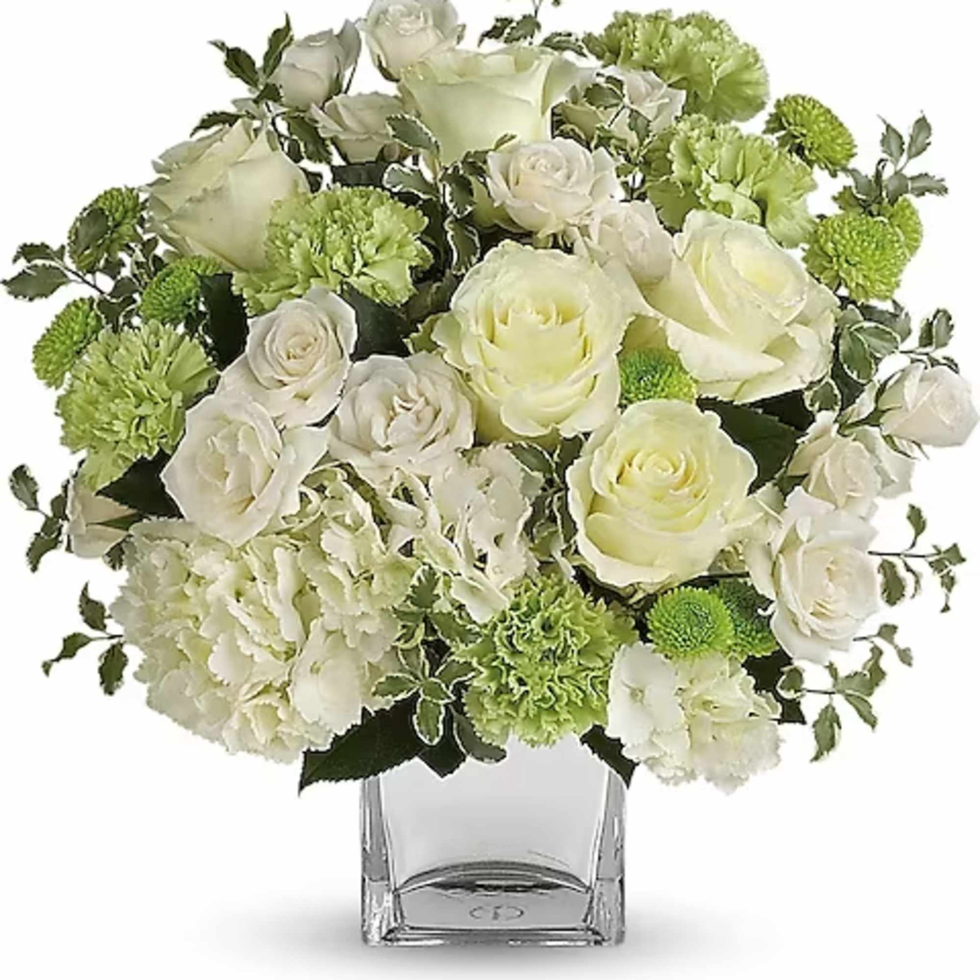 White roses and green carnations in a clear glass vase